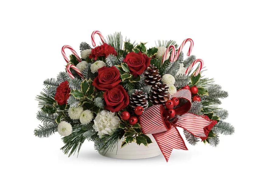 Christmas Treat  - Sweet candy cane centerpiece with christmas greens, and a mix of red and white blooms with honeycombs, ornaments and a bow for that added touch. 