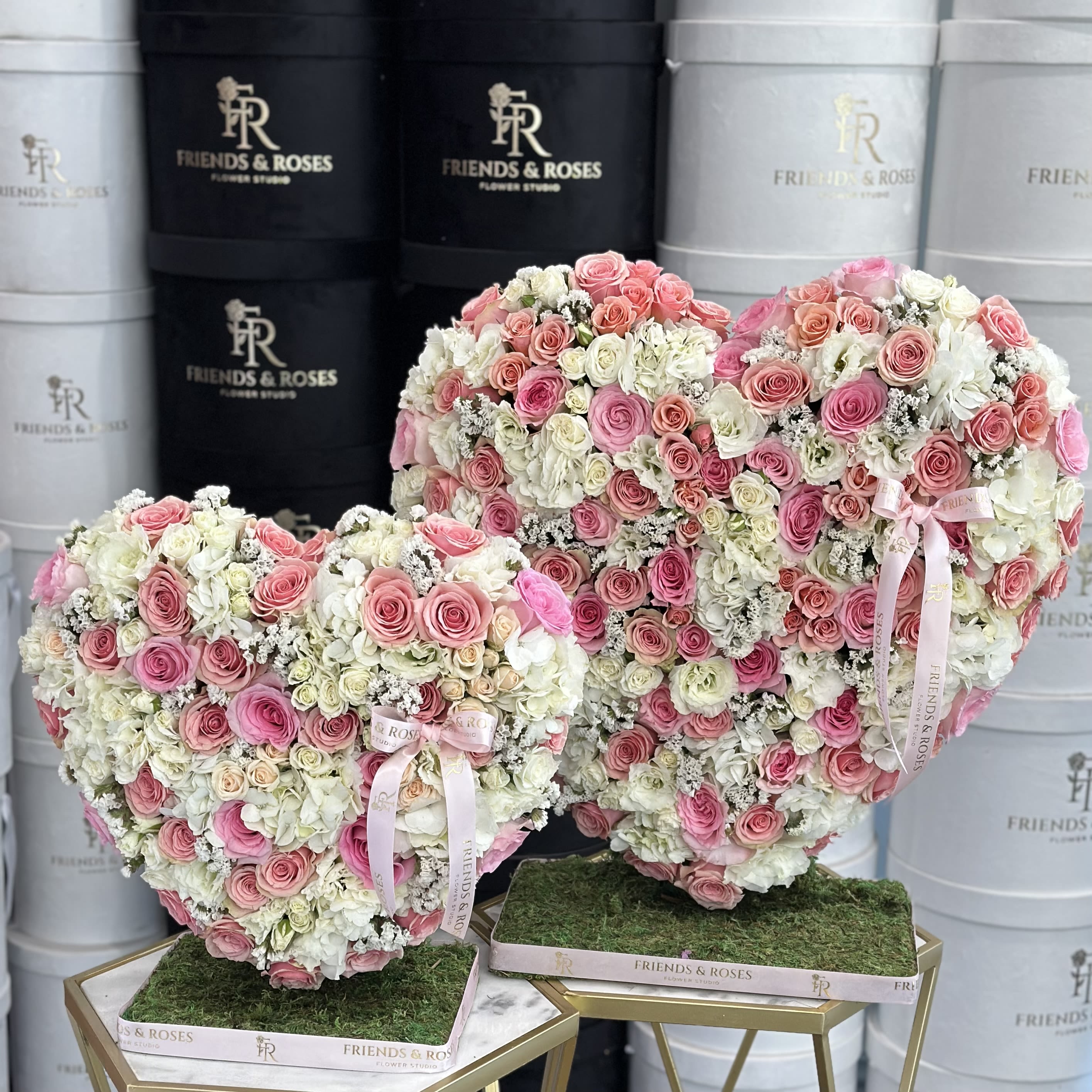 Queen &amp; Princess VD - Matching Standing Heart Arrangements for Mother &amp; Daughter Celebrate the beautiful bond between mother and daughter with this elegant pair of heart-shaped floral arrangements. Each standing heart is thoughtfully filled with a soft mix of light pink and white blooms, symbolizing love, grace, and the gentle connection shared across generations. Perfect for Mother’s Day, special milestones, or simply to honor the love between two hearts that will always be connected.