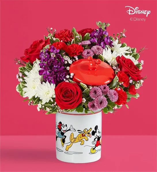 Disney Mickey Mouse &amp; Friends Cookie Jar - Romance - Share the love this Valentine’s Day with a gift full of character(s)! Part of our exclusive Disney collection, this handcrafted bouquet is gathered in radiant colors and designed in our whimsical Mickey Mouse and Friends cookie jar, featuring iconic animations of the whole gang. Great as a keepsake container or to keep delicious treats, it’s a sweet and nostalgic surprise for someone special.