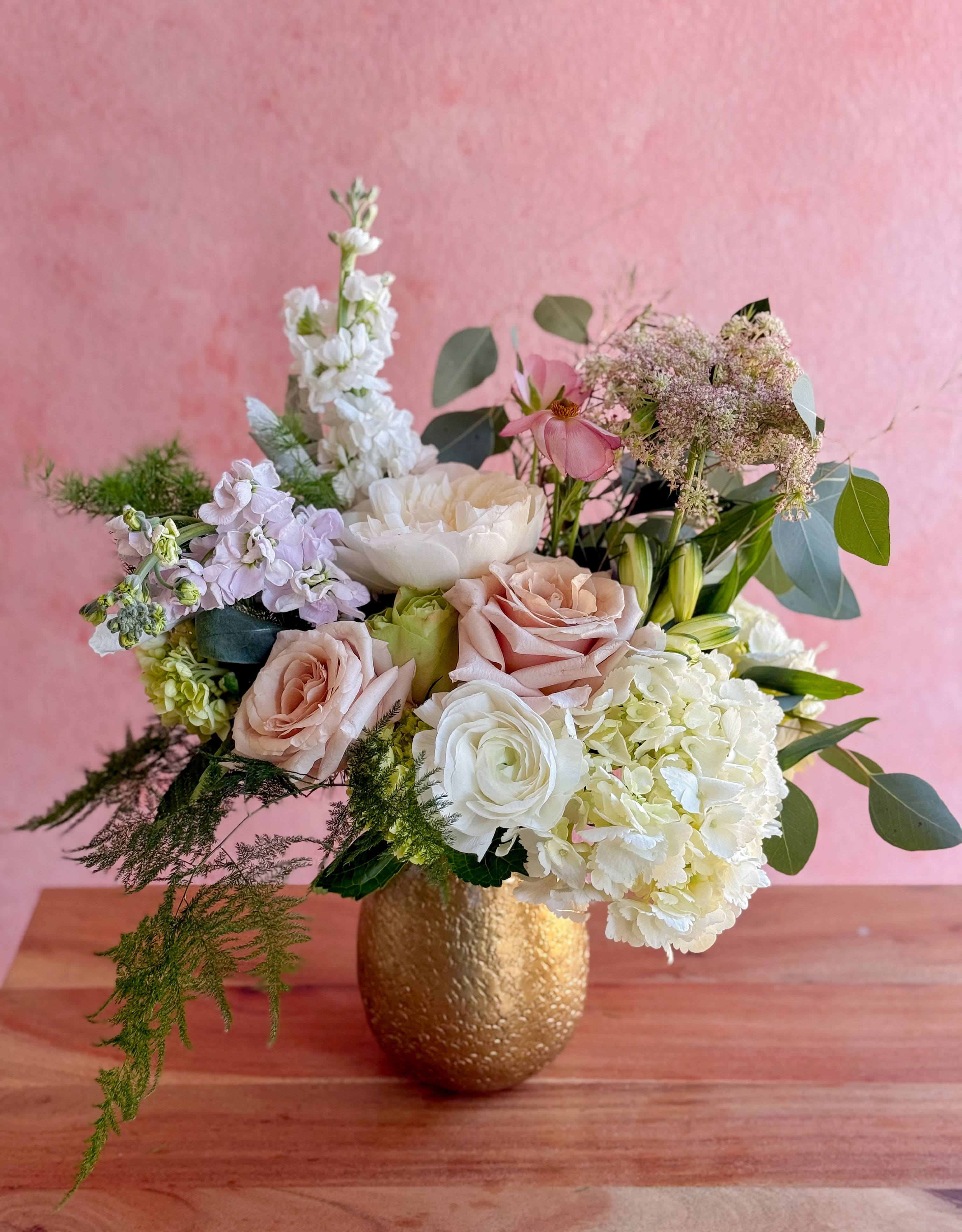 Camilla  - A seasonal lush mixed arrangement filled in a gold vase.   