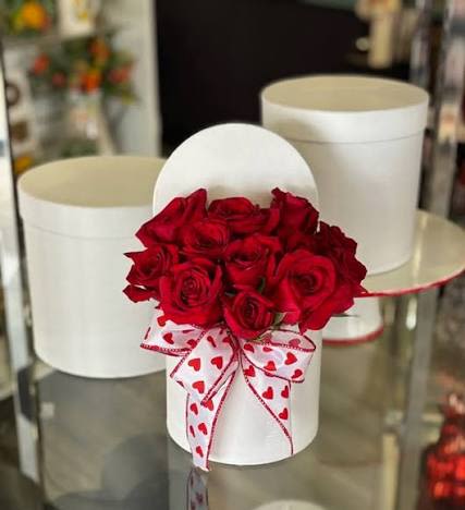 Luxury Rose's - Red roses in a cylinder Box.  Boxes can vary on color  White, Red, Black and Pink. 