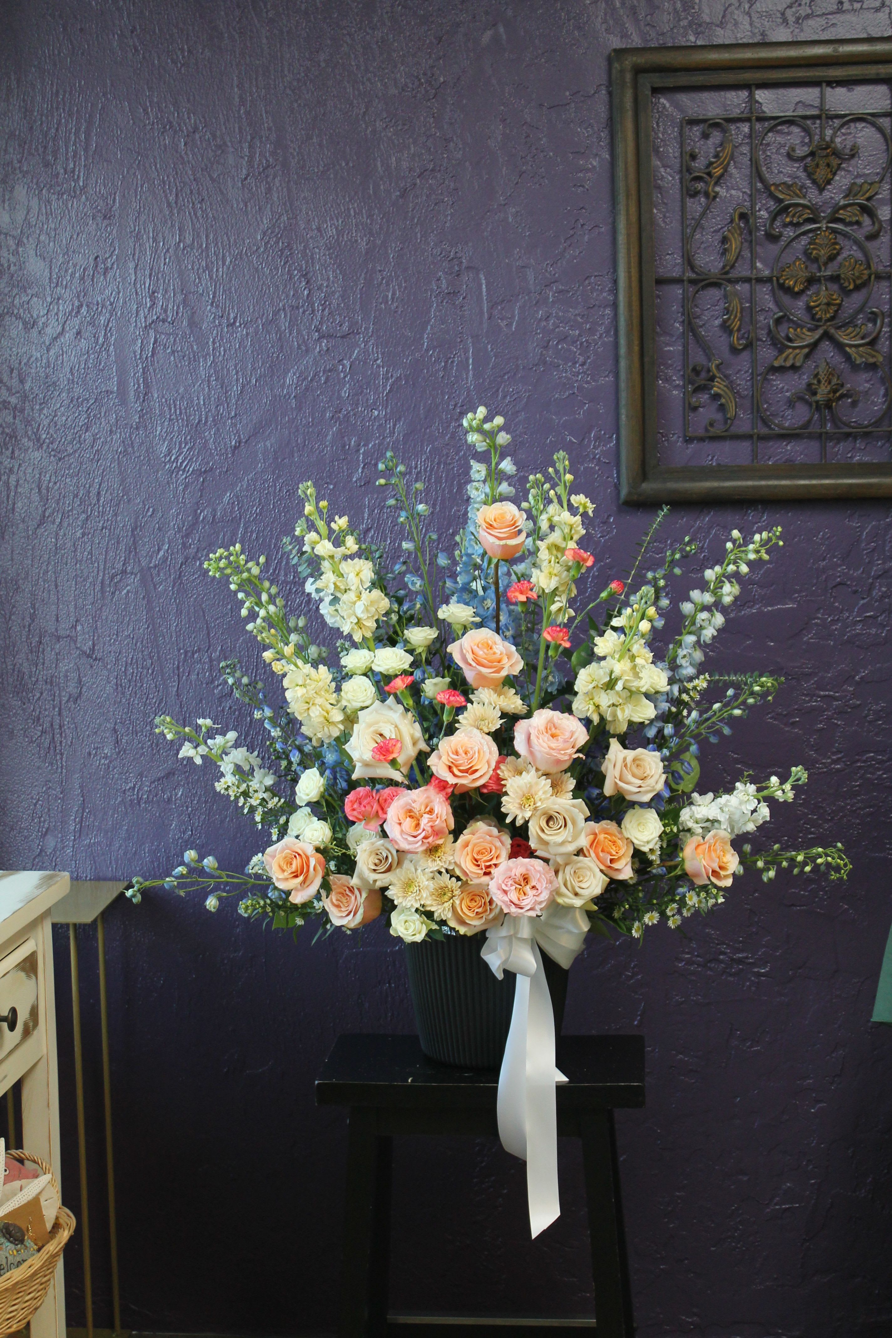 Bright Star  - A glad pink in a ceramic container featuring silver dollar eucalyptus and pink snapdragon. This arrangement smells lovely and is suitable for any type of ceremony. 
