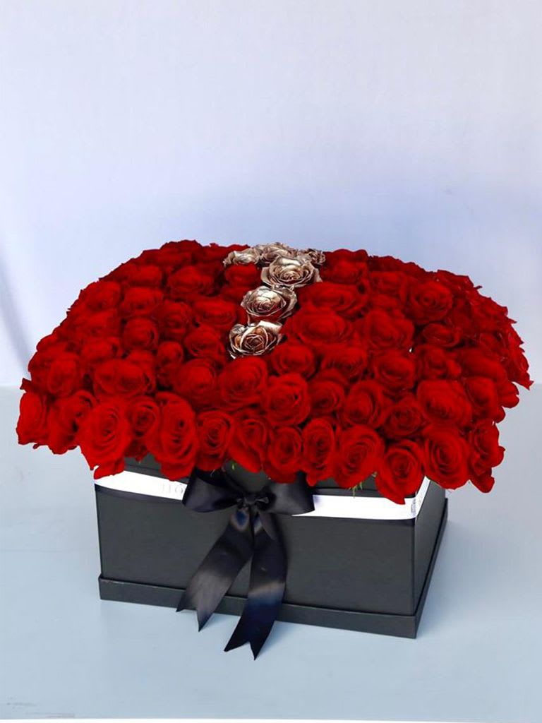 THE OBSESSION - Discover the elegance of a Red &amp; Gold Rose Letter Box Arrangement, a perfect blend of vibrant roses crafted into a beautiful letter design. Ideal for expressing love and admiration on special occasions. Order this unique and luxurious floral gift today!