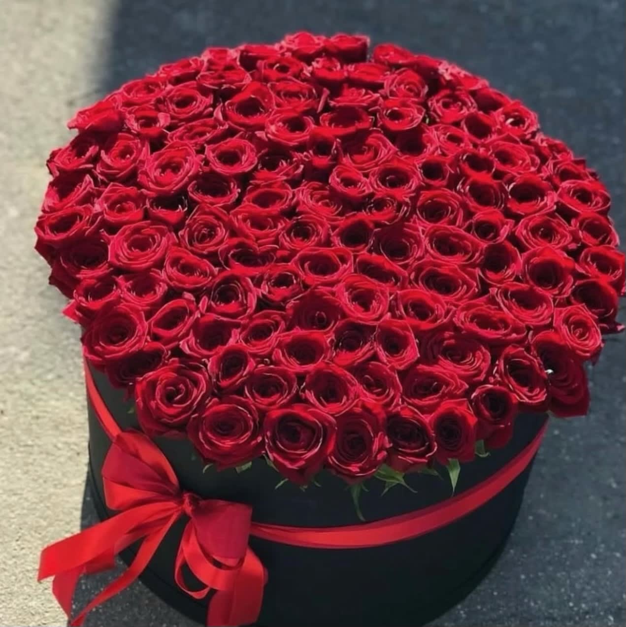 Truly stunning box - 75 fresh red roses put together in a black box and topped off with a ribbon.