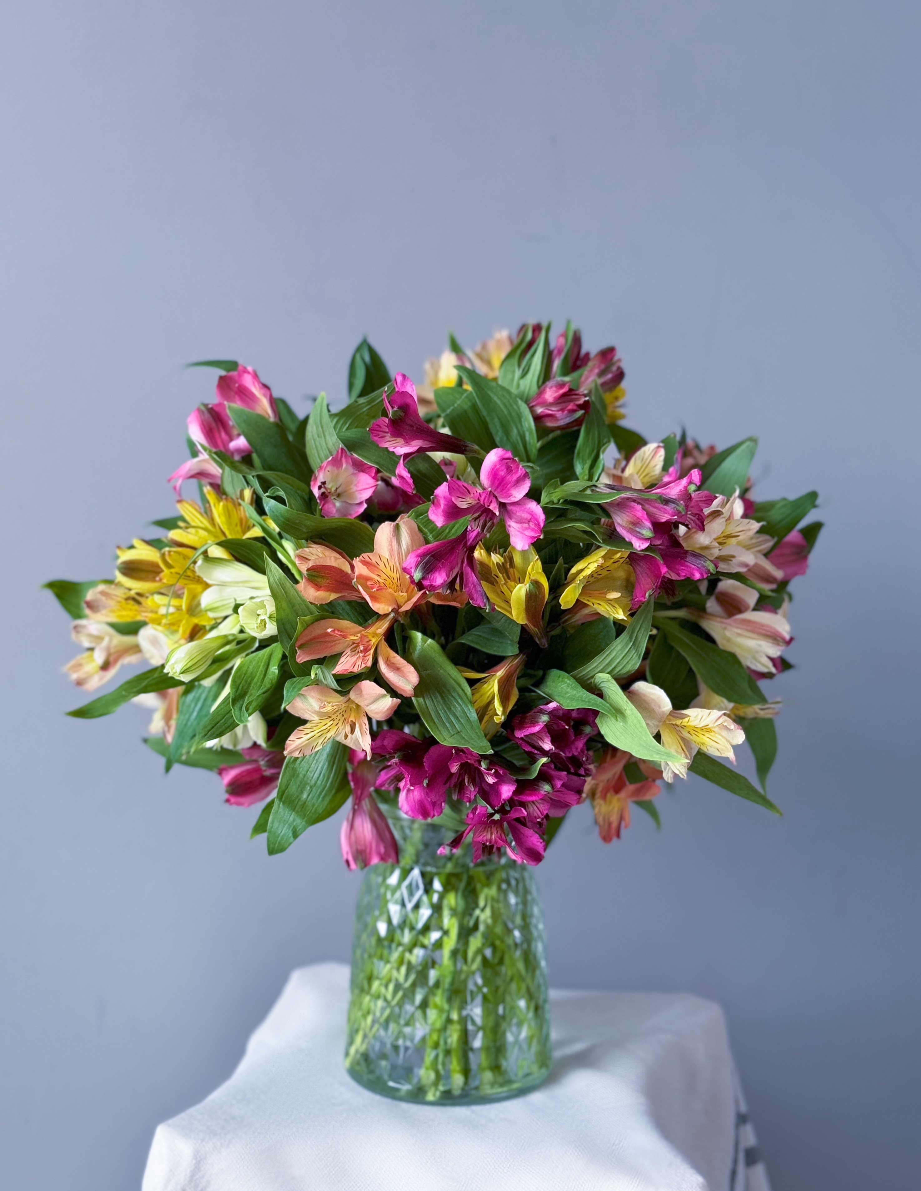 Field of Alstroemeria  - A beautiful blend of colorful alstroemeria mixed with greens. A wonderful way to bring your garden inside!  *Please note our floral and color palette changes from week to week. All substitutions are of equal value