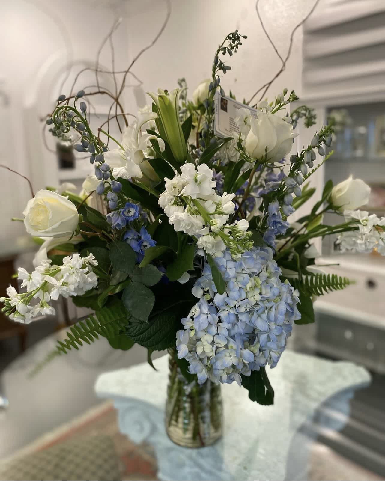 Beauty in Blue - This beautiful mixture of blue and white flowers is calming bouquet that evokes peace and tranquility. 