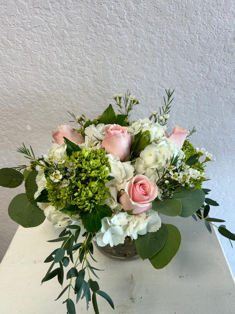 V102 - A beautiful mixed arranged of white, pink and greens with flowers such as white hydrangeas, mini green hydrangeas and pink roses. 