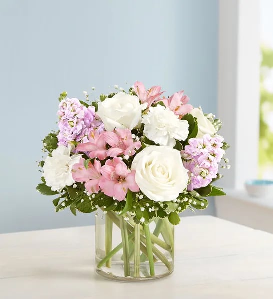Elegant Blush Bouquet - Our elegant bouquet in shades of blush pink and creamy white brings all the charm of a rustic country garden to the people you care about. Cascading blooms are hand-gathered with lush greenery and designed in a clear cylinder vase, creating a beautiful gift that delights with every detail. - ALSTROEMERIA *** MAYBE ARRIVES IN BUD FORM****