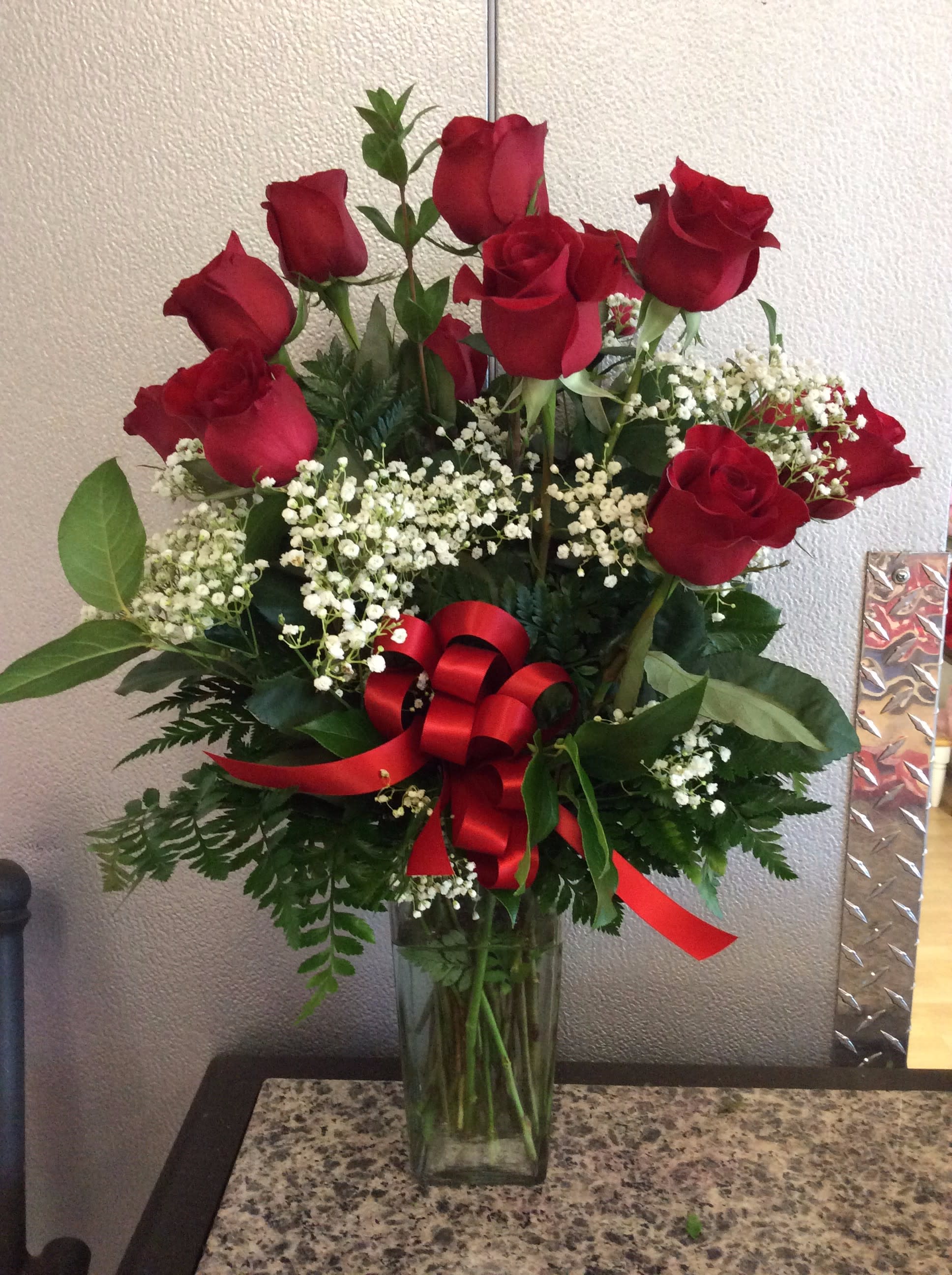 Dz. Red Roses w/ Babies Breath - 12 Red Roses arranged in glass vase w/ filler &amp; greens - Approx. Height 19"