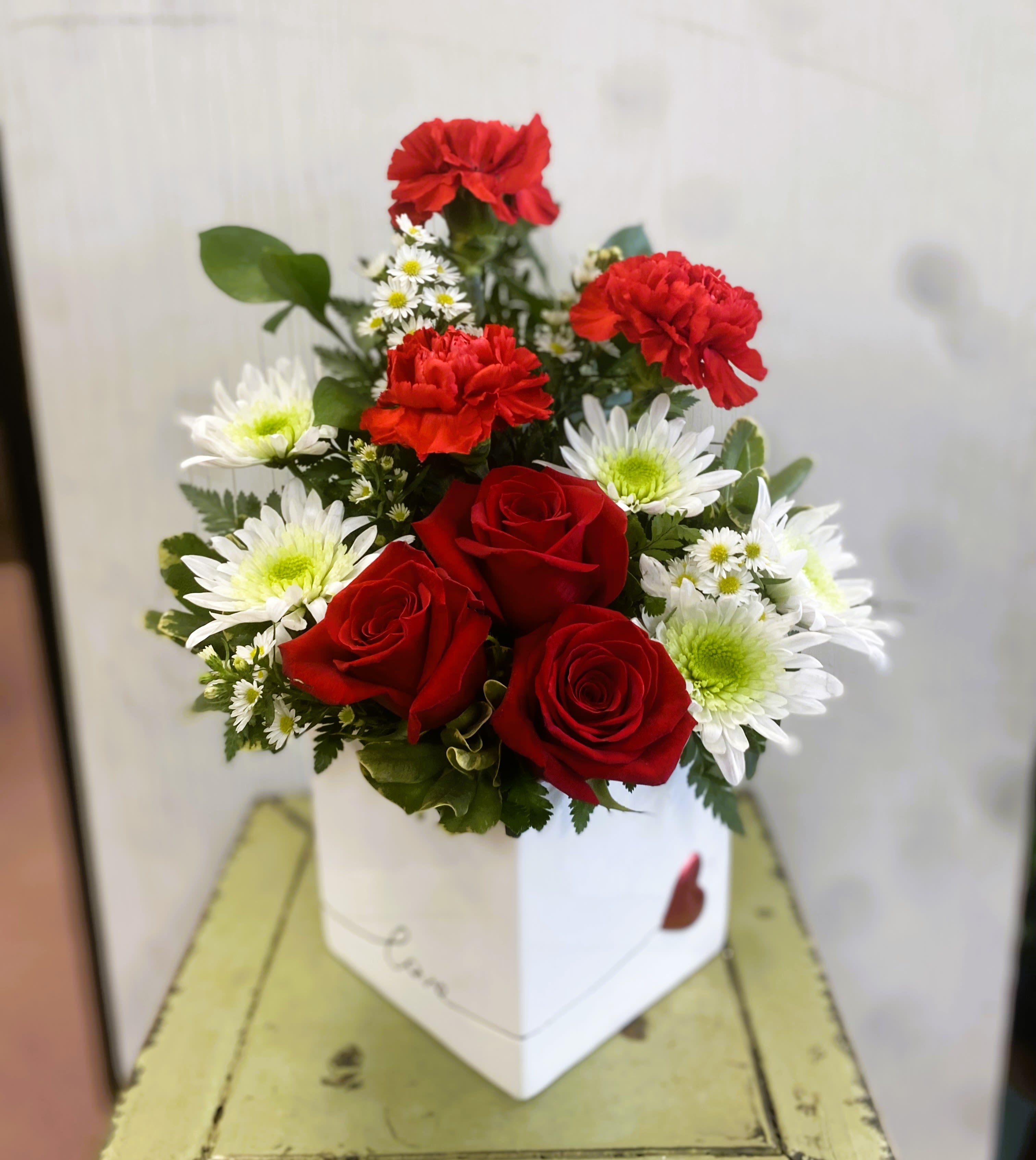 Love You Arrangement - Say Love You! with this stylish arrangement.  Red roses and carnations arranged in a special LOVE ceramic container!