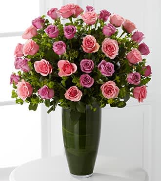 Serenade Luxury Rose Bouquet - 24-inch Premium Long-Stemmed Roses - A simple song to enhance the beauty of their day. An exquisite bouquet that will have them speechless. Take their breath away with our finest pink and lavender 24-inch premium long-stemmed roses gorgeously situated in a highly sophisticated 14-inch clear glass tapered bullet vase to create the perfect moment for love to bloom. Includes: 20 stems of 24-inch premium long-stemmed pink roses, 20 stems of premium long-stemmed lavender roses, assorted greens, exotic foliage and a superior 14-inch clear glass tapered bullet vase. Approx. 30H x 22W
