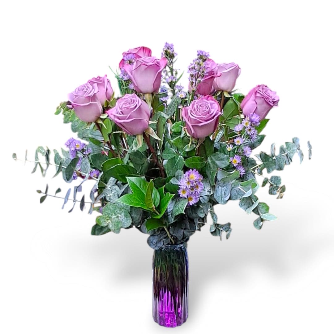 Amethyst   - This beautiful arrangement is made up of purple roses, eucalyptus, monte casino and other greens. All placed in a tall vase.