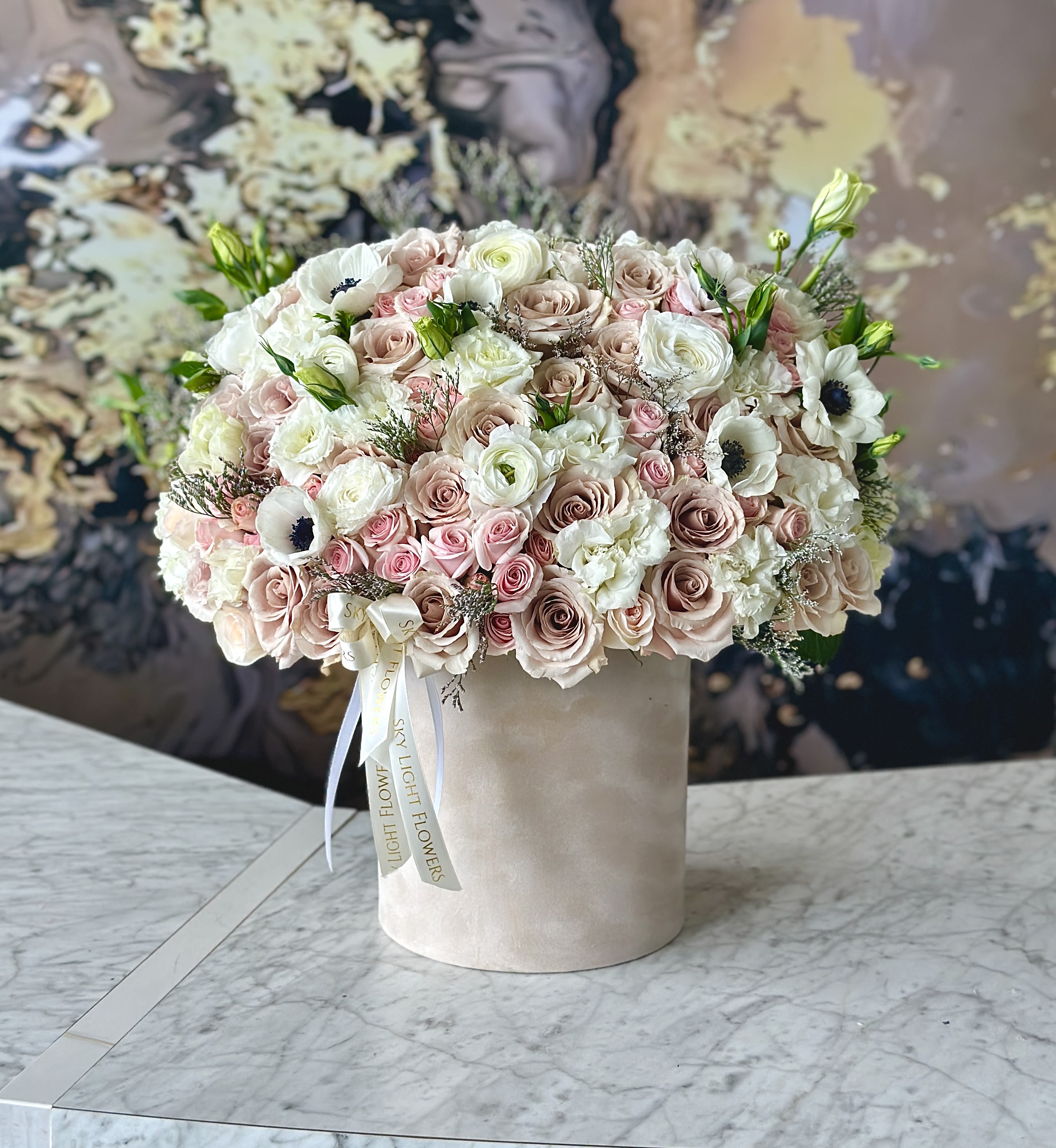 Pink blossom  - Brighten any space with our Elegant Flower Box Arrangement! Bursting with vibrant blooms, this stunning display combines seasonal favorites with lush fillers.   Housed in a chic, reusable container, it makes a perfect centerpiece for any occasion be it a gift or a treat for yourself. Elevate your decor with this captivating arrangement that brings joy and sophistication to your home or office. Order yours today and let the beauty of flowers inspire you!