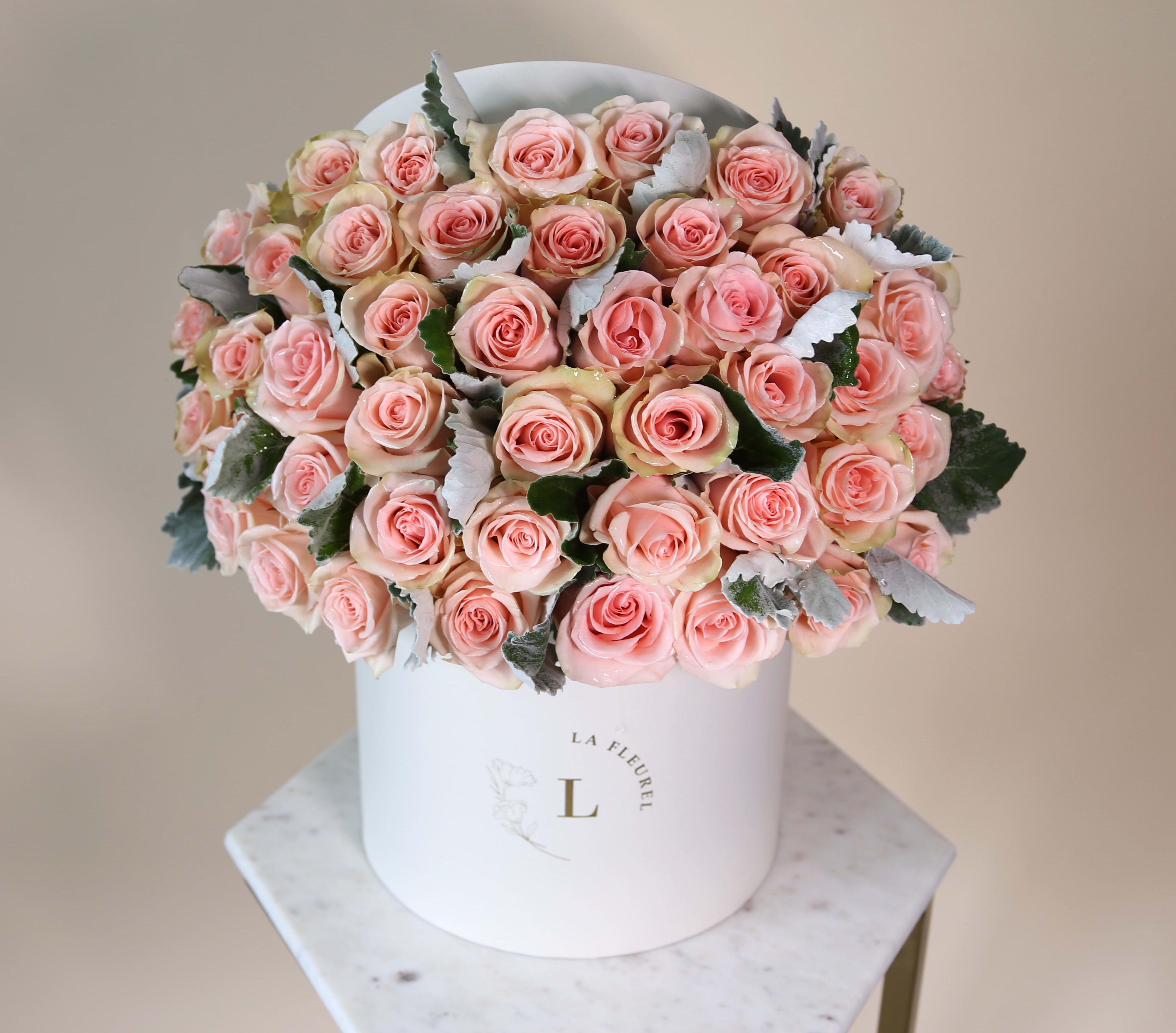 Peach Perfect  - This beautiful box contains a combination of 45 to 50 fresh roses in an ivory box. This floral arrangment is the perfect gift for your loved one!   Large Size - 100 Roses   Arrangement includes: Fresh peach roses Medium box measured at 9.75" Dia. x 9.25" H Custom greeting card