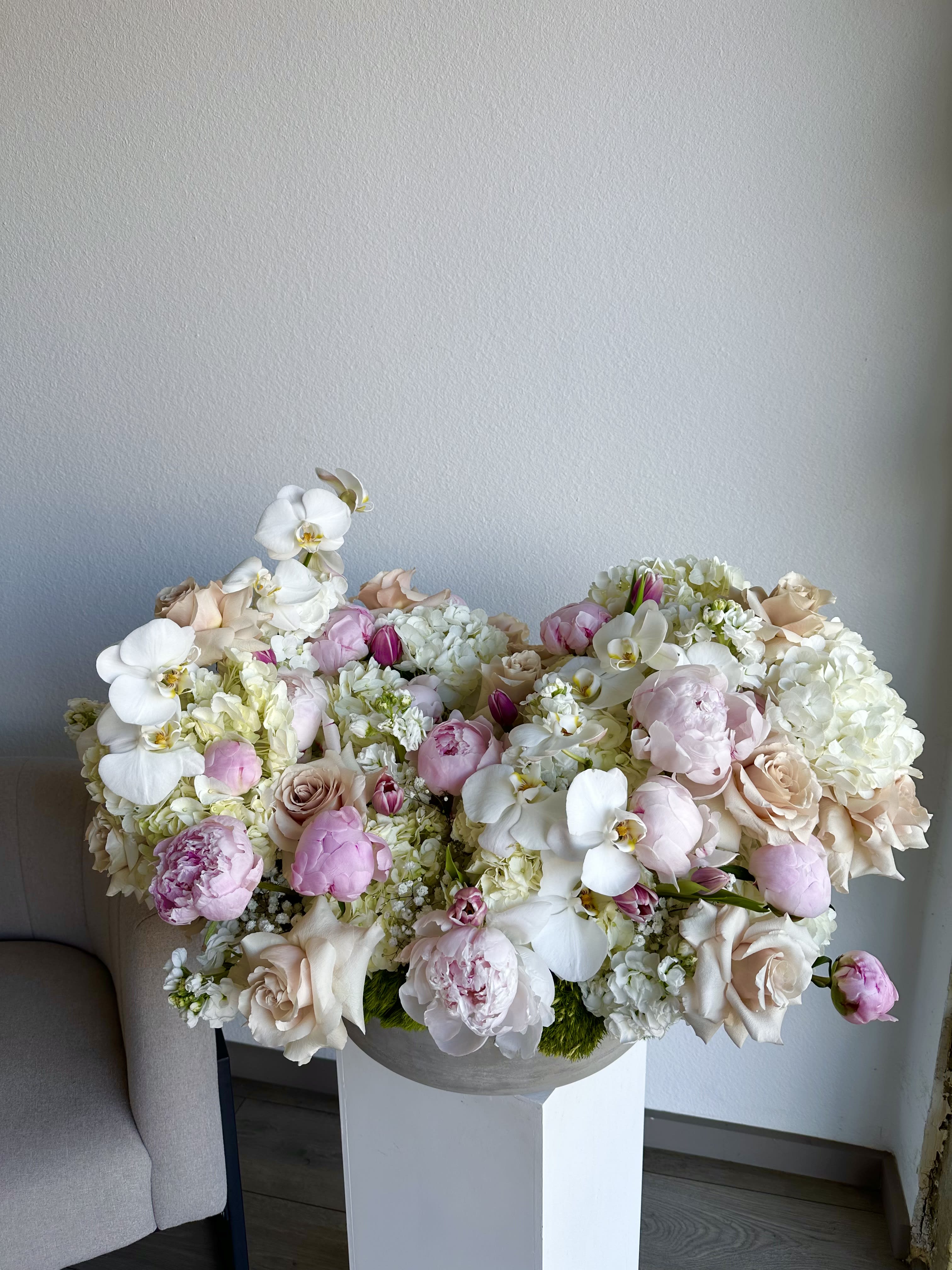 Emma's Enchantment - This Extra Large romantic arrangement includes roses, hydrangeas, peonies, orchids and greens.  Perfect for any occasion.  Arrangement includes:  Concrete Vase Custom greeting card