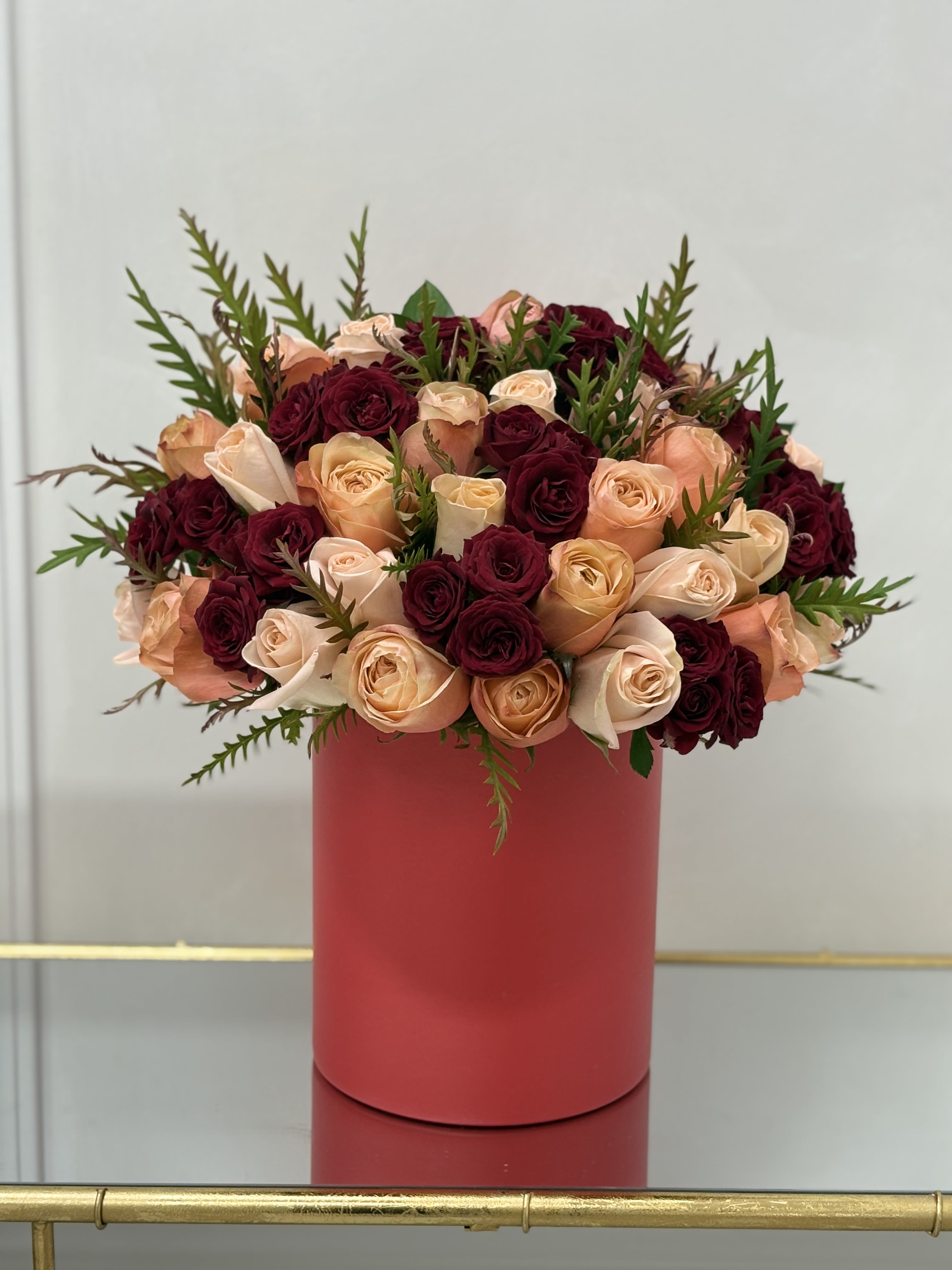Red And Peach Hat Box By VLM Flowers - Peach roses and red spray roses in a red hat box.