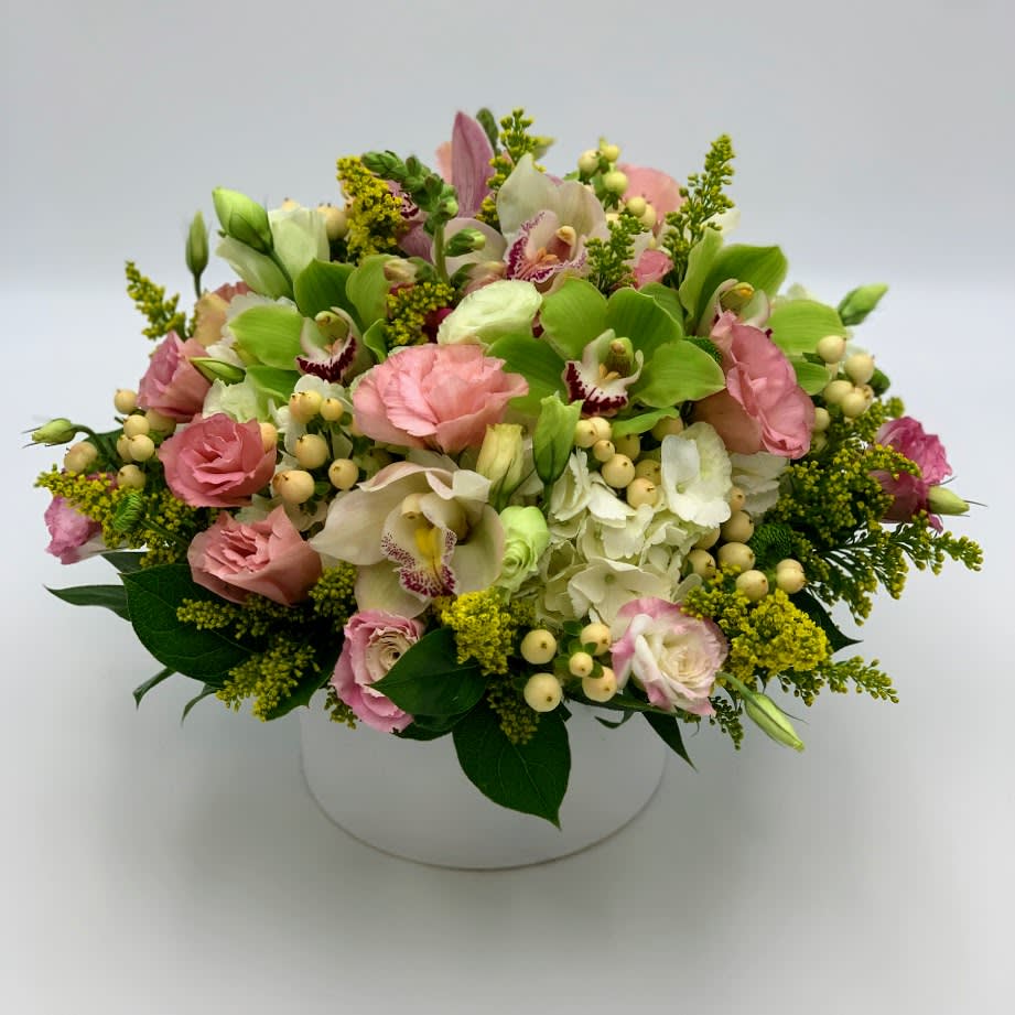 Garden Blooms - A mixed and elegant bouquet designed with delicate flowers as Lisianthus blooming over white hydrangeas and our unique Cymbidium orchid flower for a touch of luxury accented with Solidago and Yellow Hypericum to insure a beautiful bouquet. 