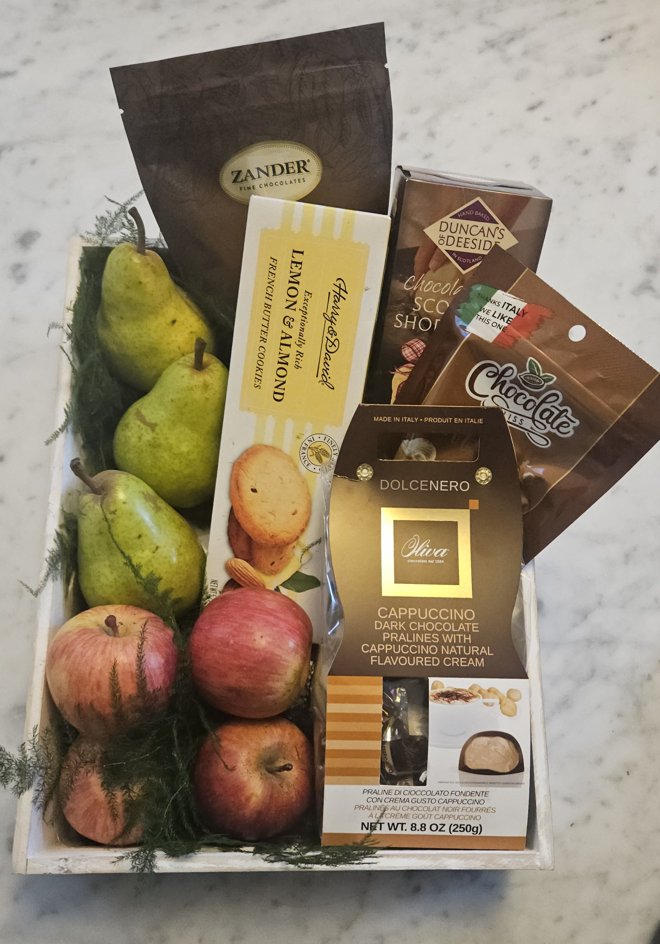 Gift Basket - A beautiful wooden box assorted with tasty chocolates, crackers and seasonal fruits or flowers.