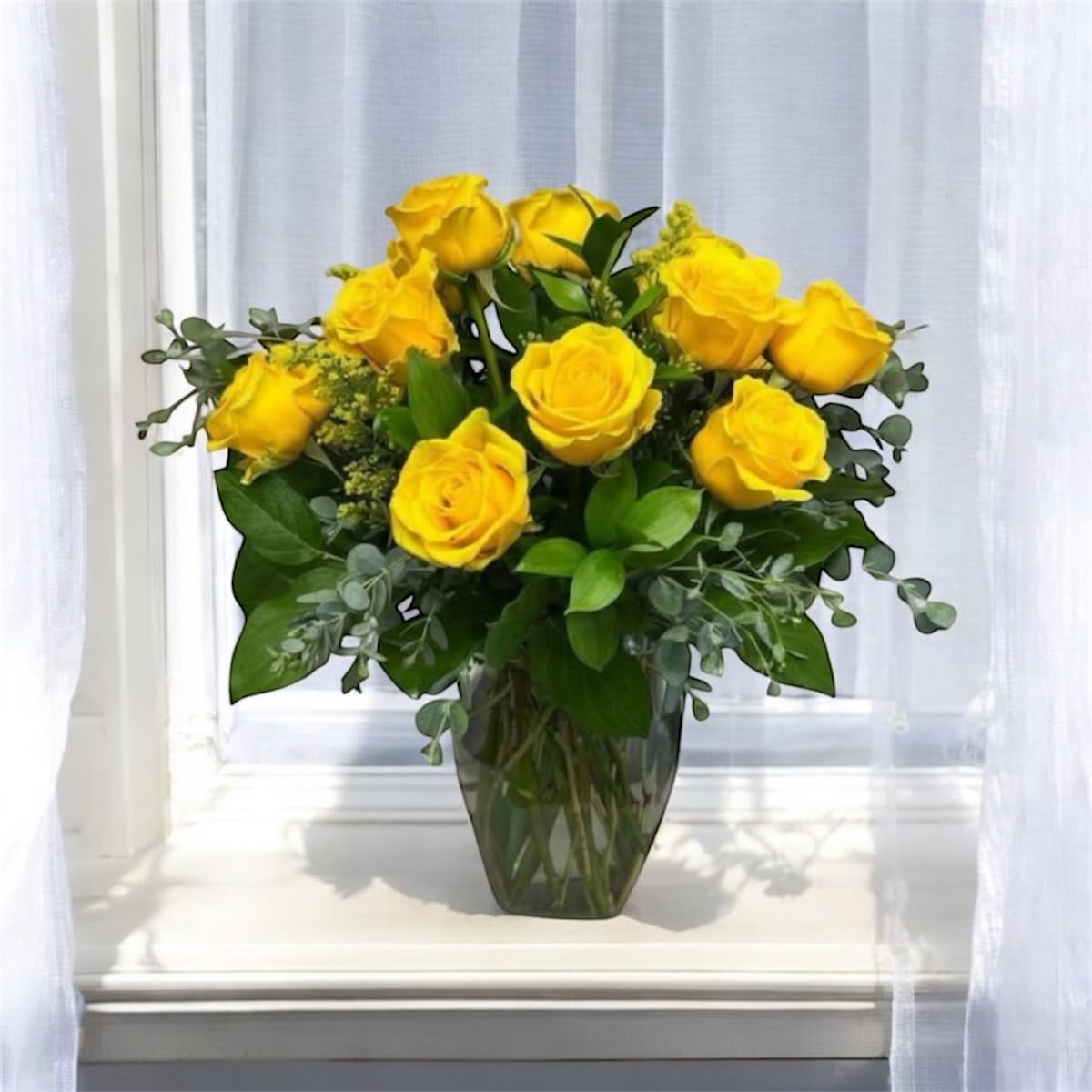 Brighter Day - Bring instant sunshine into any space with Brighter Day. This radiant arrangement features vibrant yellow roses nestled among lush seasonal greenery, thoughtfully designed in a clear glass vase. Bursting with warmth and joy, this bouquet is perfect for celebrating milestones, lifting spirits, or simply letting someone know you’re thinking of them.  Thanks for shopping our website.