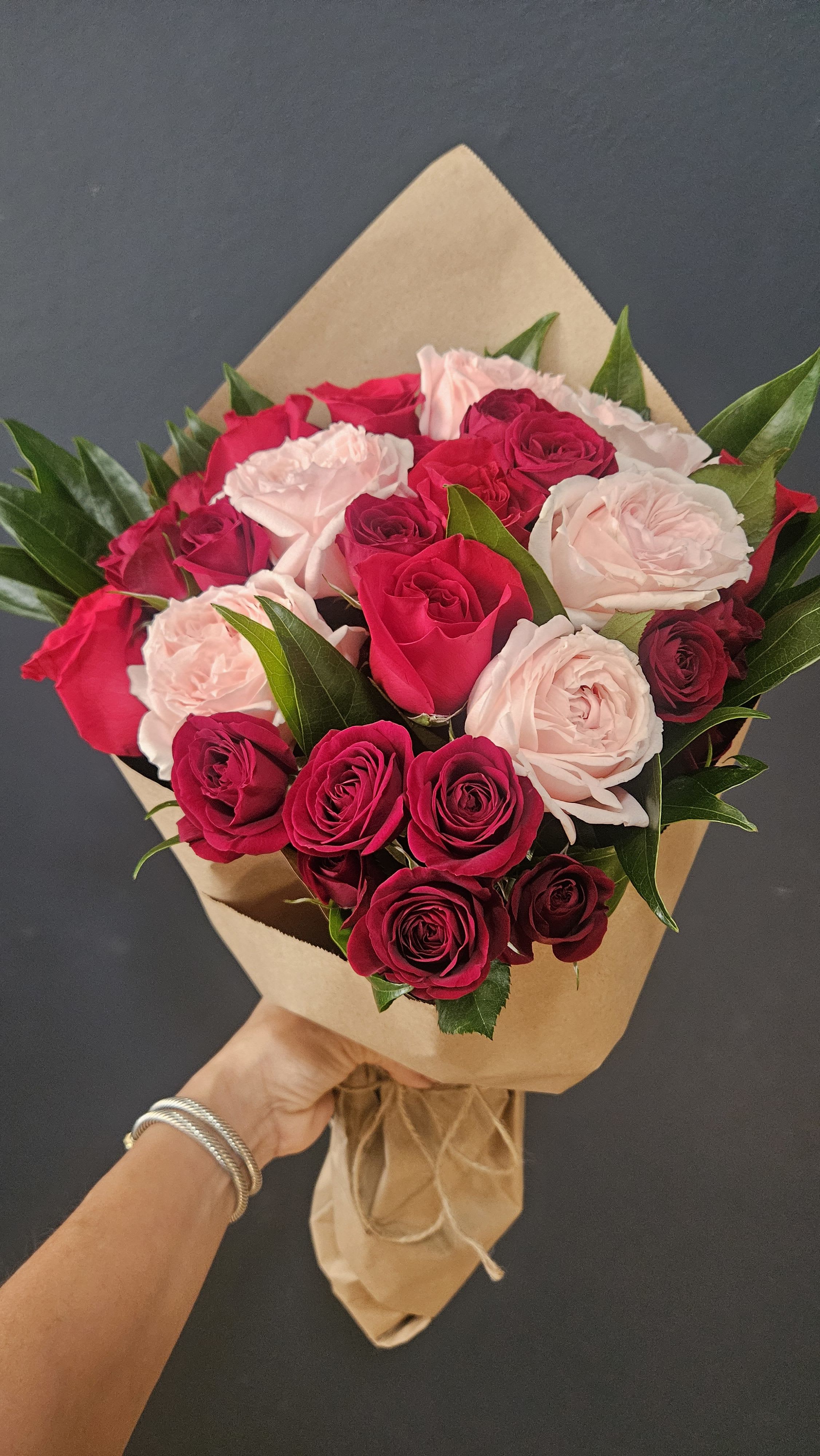 Valentina - A beautiful wrapped arrangement  Of six red roses, six fragrant garden pink roses and red spray roses and soft greenery.