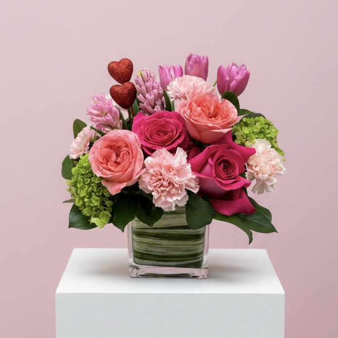Petal Crush Bouquet - VALENTINE'S DAY COLLECTION | LOCAL DELIVERY ONLY  Celebrate love with a cutesy Valentine's Day arrangement filled with mojito hydrangeas, tulips, roses, and carnations. Designed in a clear cube vase. "Petal Crush Bouquet" is a fun way to say "I Love You." Flowers &amp; colors may vary, making each bouquet a unique expression of love. 