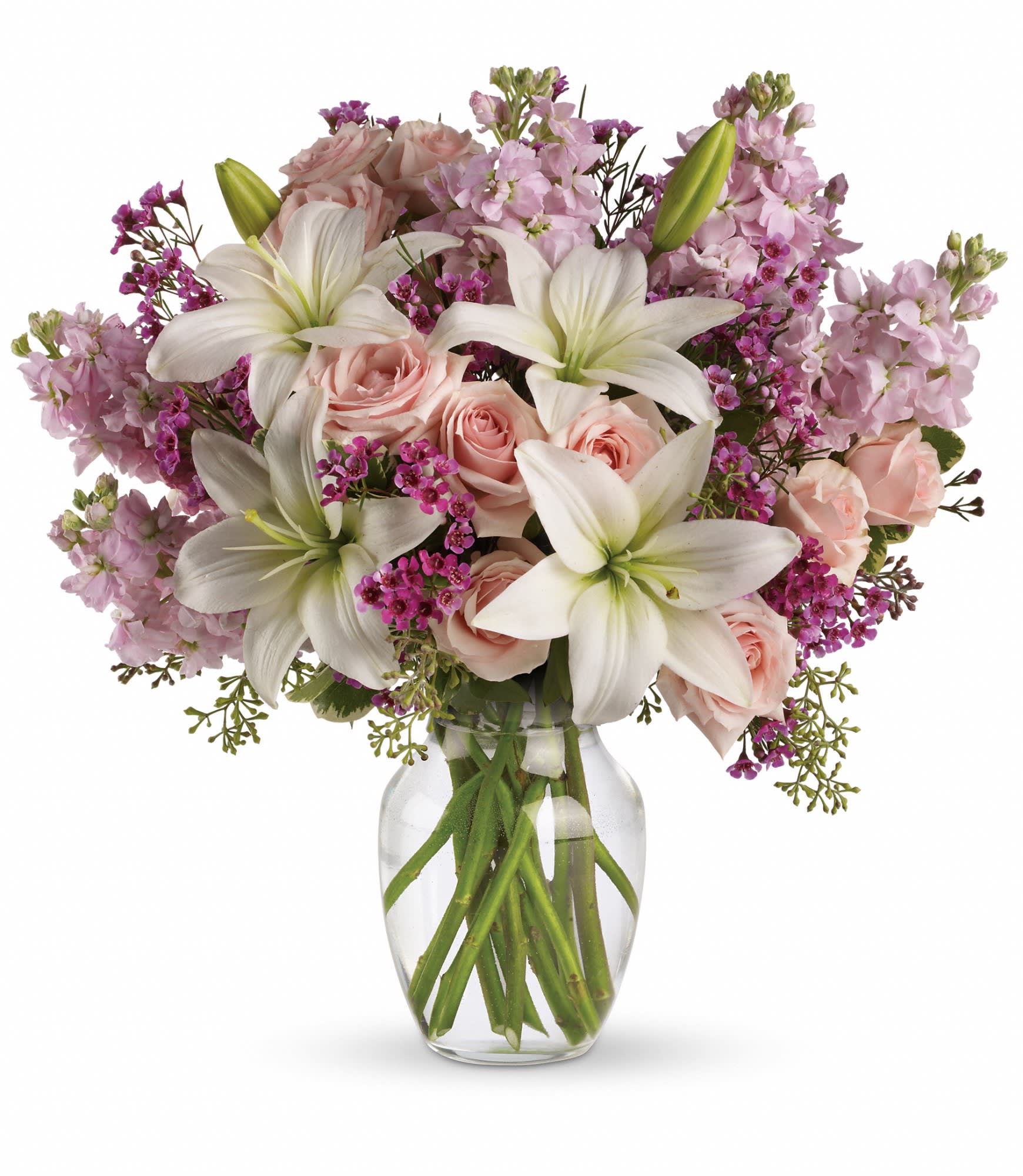 Blossoming Romance - Love is in the air. Or if it isn't, it will be when you surprise her with a gorgeous array of light pink spray roses, fragrant white lilies and other favorites in a sparkling glass vase. You know when she'll love it the most? When it's a total surprise. 