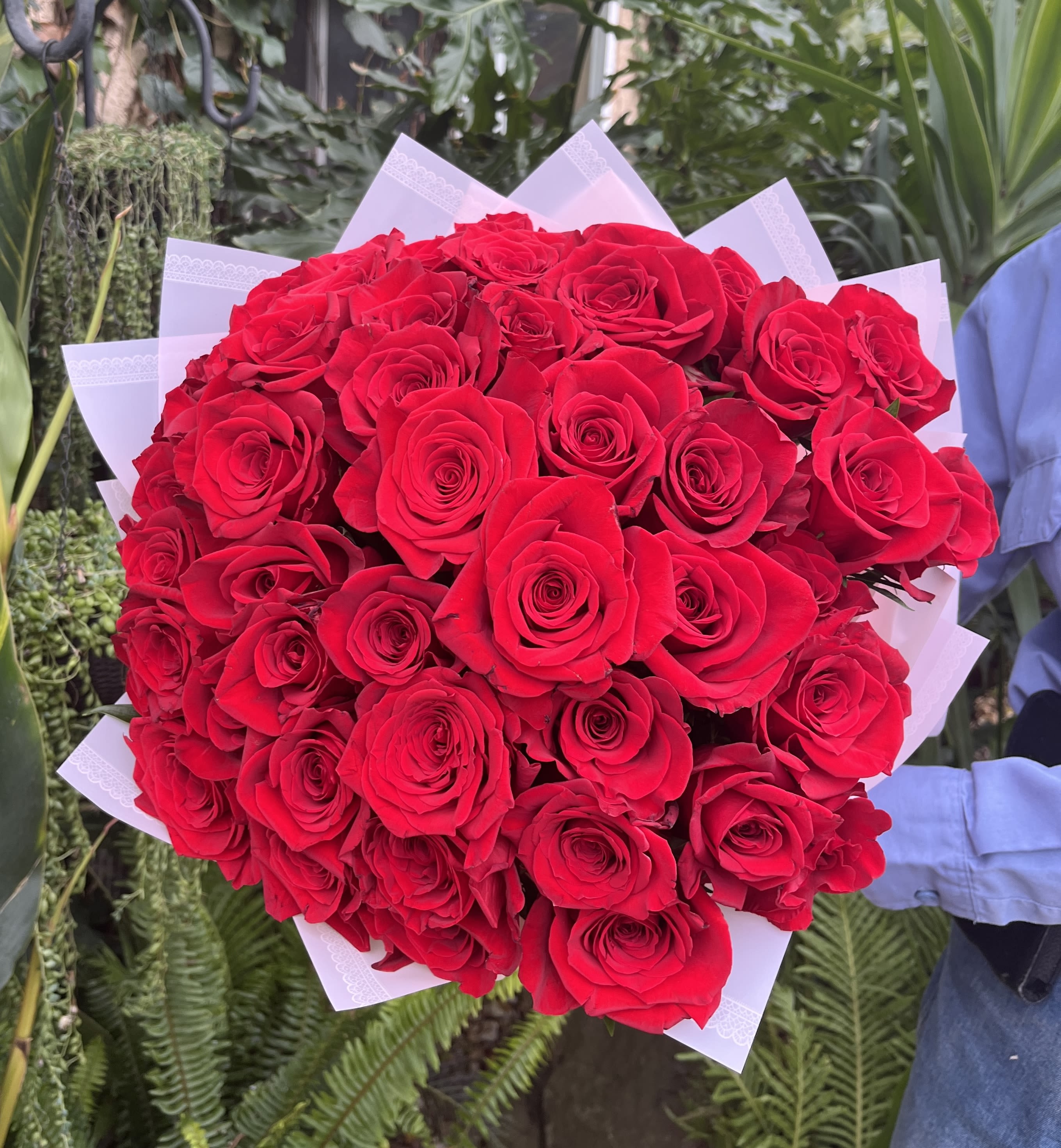 50 red roses hand tied  - Hand held bouquet of 50 red roses.