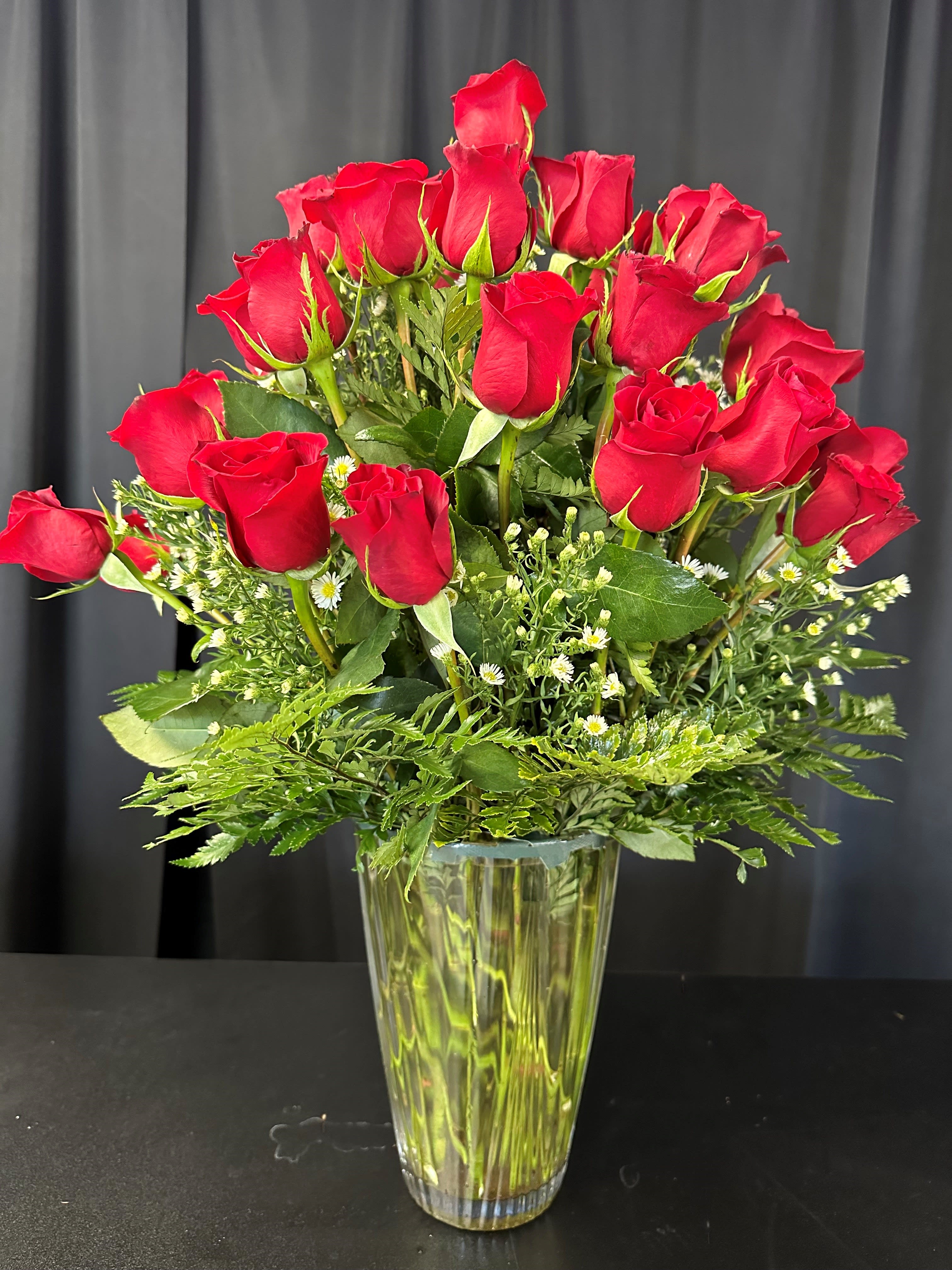 3 Dozen Long Stem Roses -  Make a bold declaration of love with our extravagant arrangement of three dozen red roses, perfect for Valentine's Day, anniversaries, or any grand expression of affection. This luxurious bouquet is designed to make a statement, delivering a resounding "I love you" with its stunning display of 36 roses. Let your love shine bright with this lavish gesture that promises to leave a lasting impression of romance and devotion. Approximate Dimensions: 20"D x 32"H