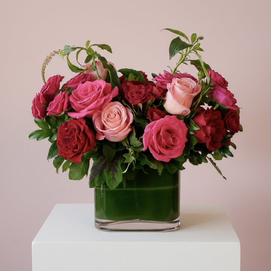 Rosita Garden - Designed for romance, this elegant arrangement showcases a lush blend of premium red and pink roses, delicately accented with spray roses and layered seasonal greenery. Styled in a leaf-lined vase, it offers a timeless expression of love and sophistication. The arrangement measures approximately 15 inches tall and 18 inches wide, creating a beautifully abundant presentation.  Handcrafted by our floral designers in West Los Angeles, Rosita Garden is available for flower delivery throughout Santa Monica, Beverly Hills, Brentwood, Westwood, Pacific Palisades, Culver City, and surrounding Los Angeles neighborhoods.