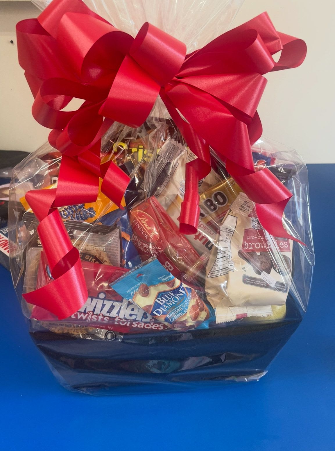 Treat Basket - Think outside the vase, while flowers are always beautiful and thoughtful, sometimes the best gift needs to be tummy satisfaction. Why not treat someone to a gift of snacks and goodies. Salty, sweet and savory. Order our standard basket or if there are dietary needs please let us know if we have to include some sugar free snacks. Great to send as a get well hospital surprise,  for a family treat night or to wish someone a Happy Birthday.  