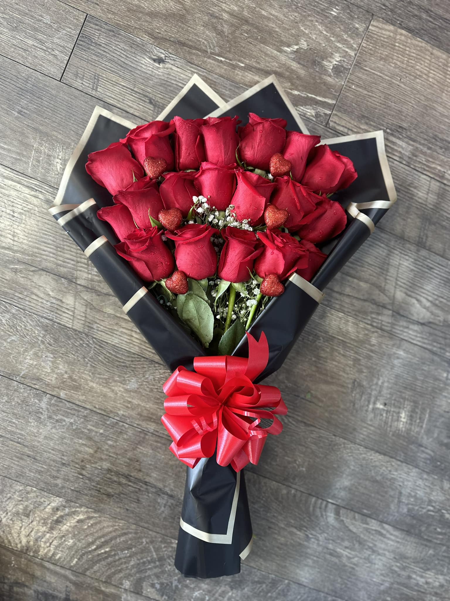 red roses in layers  - red roses in layers, wrapped in black floral paper, perfect for any occasion. Anniversaries, birthday celebration or mothers day! a dozen and a half