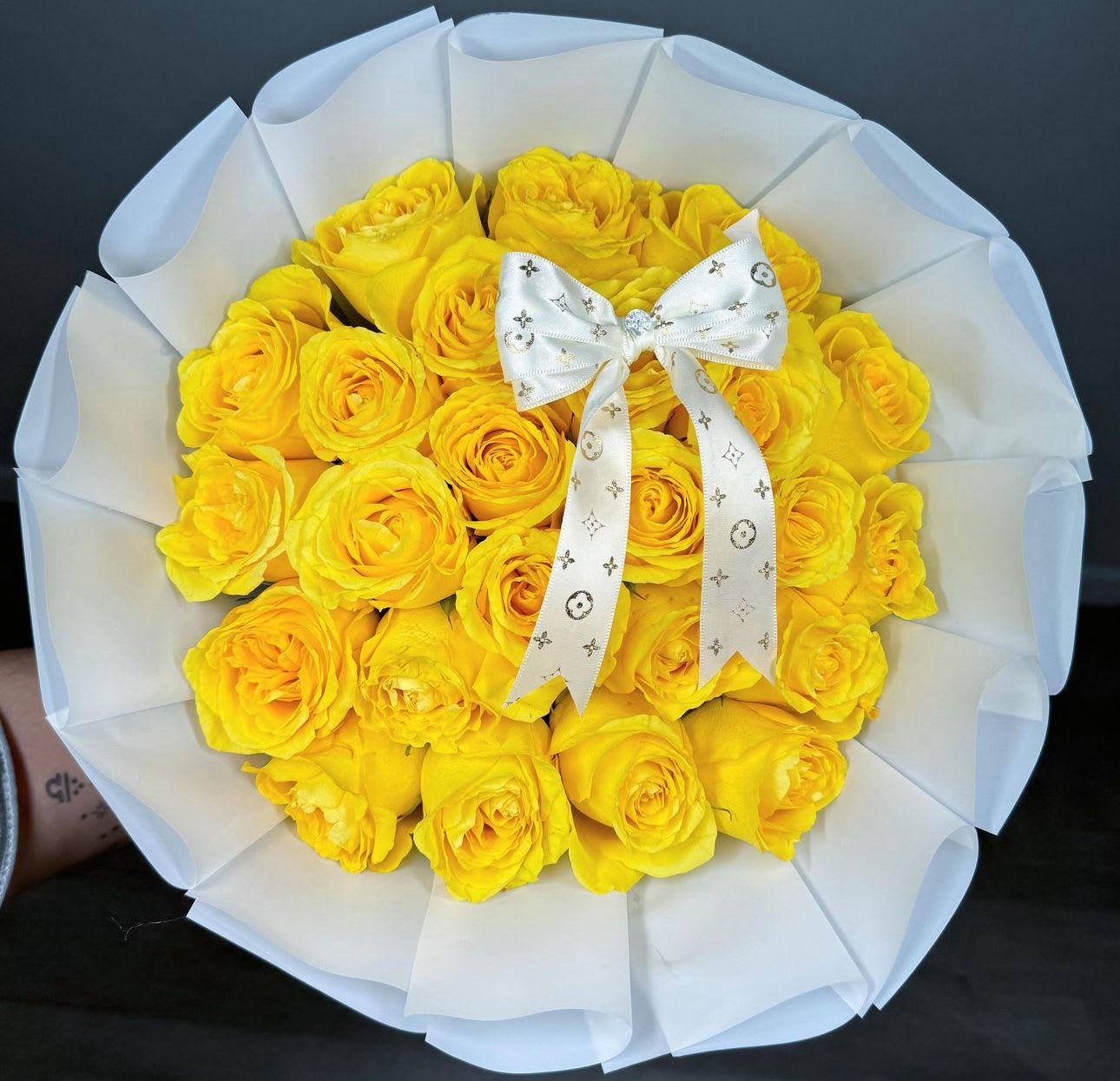 bright yellow times - gorgeous yellow roses wrapped in beautiful white floral paper. and topped off with a white bow.