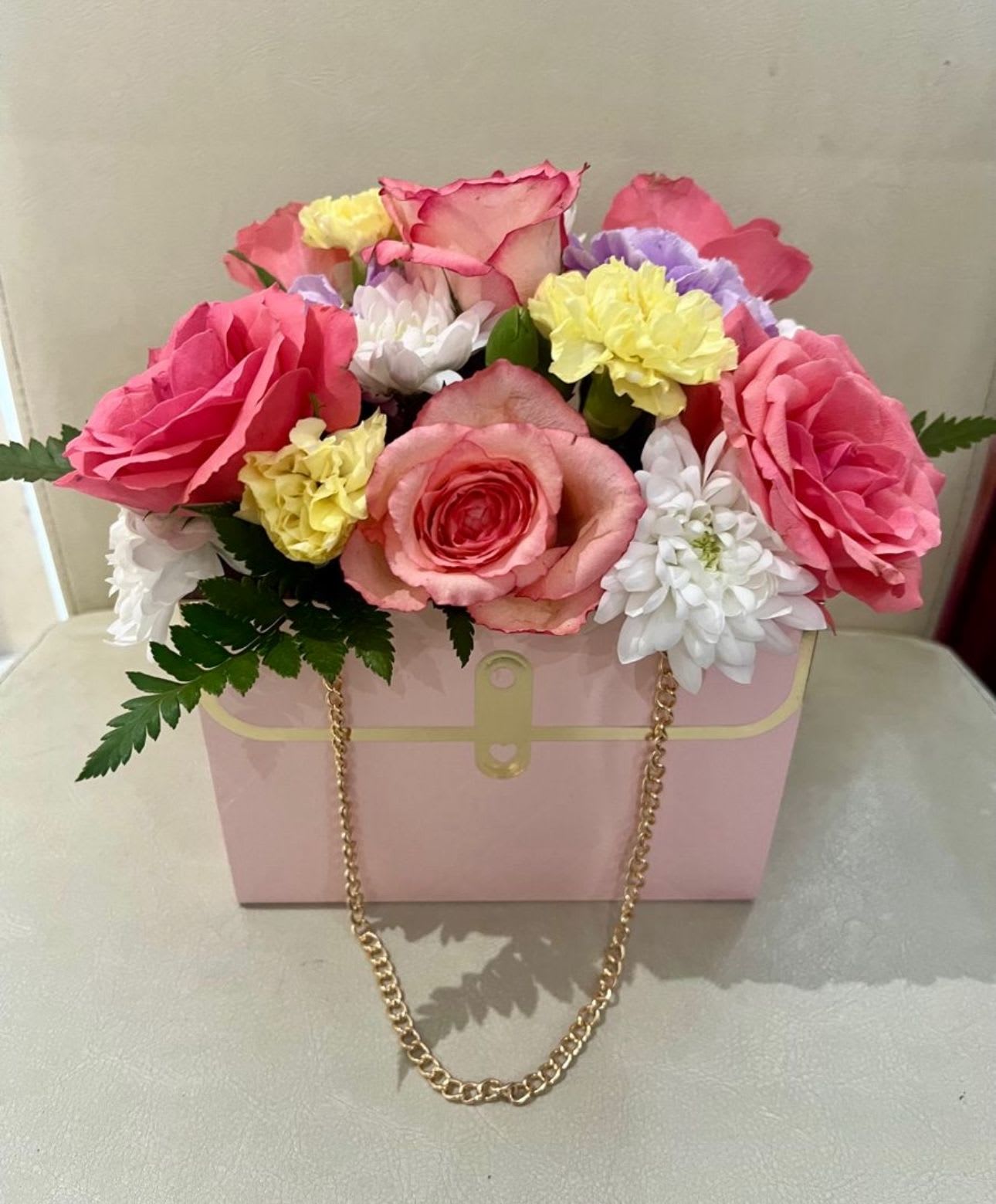 Berry bloomy purse mix - pink roses with white and greenery filling in a purse. perfect for any occasion.