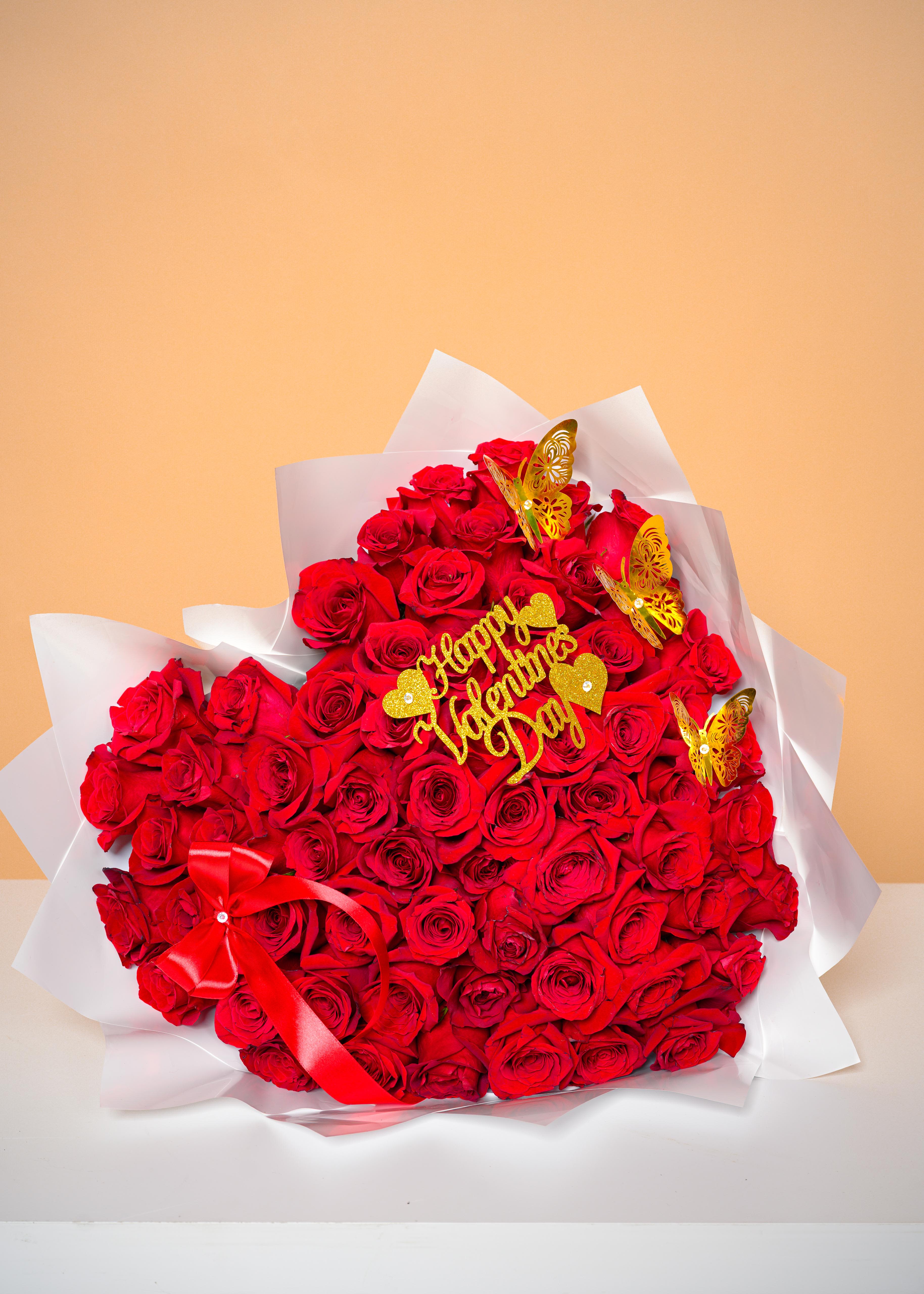 All My Heart Bouquet - A breathtaking heart-shaped arrangement crafted from luxurious red roses, symbolizing deep love and passion. Accented with delicate golden butterflies, a satin red ribbon, and a shimmering Happy Valentine’s Day detail, this design radiates romance and elegance. Wrapped in soft white layers and beautifully presented,  is the perfect statement piece to celebrate Valentine’s Day, anniversaries, or any moment meant to say “I love you” in the most unforgettable way.