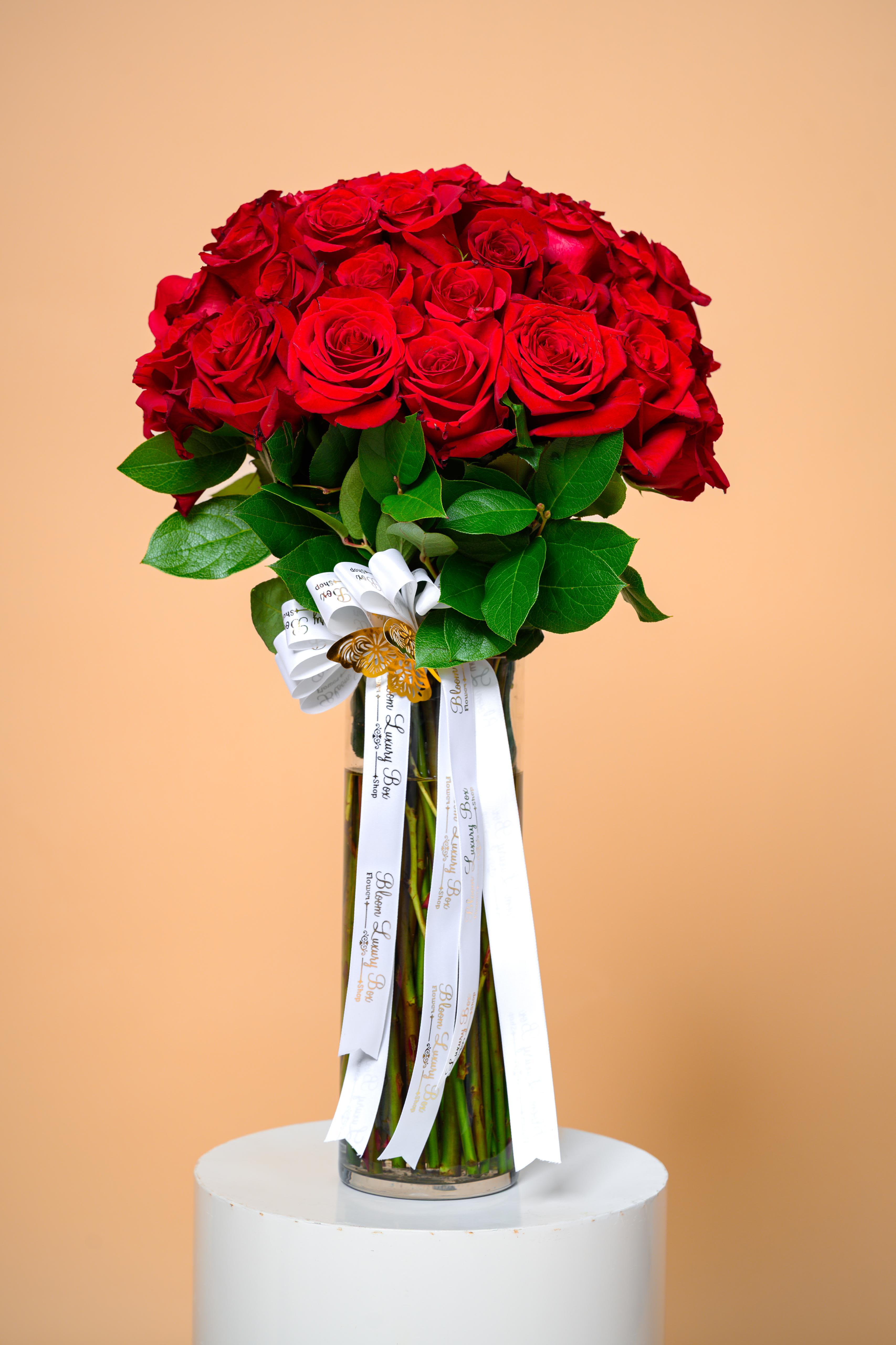 Signature Red Luxe - Our signature red rose arrangement featuring premium blooms, rich greenery, and an elegant presentation. Signature Red Luxe is a statement of love, confidence, and refined taste—perfect for those who appreciate classic luxury.