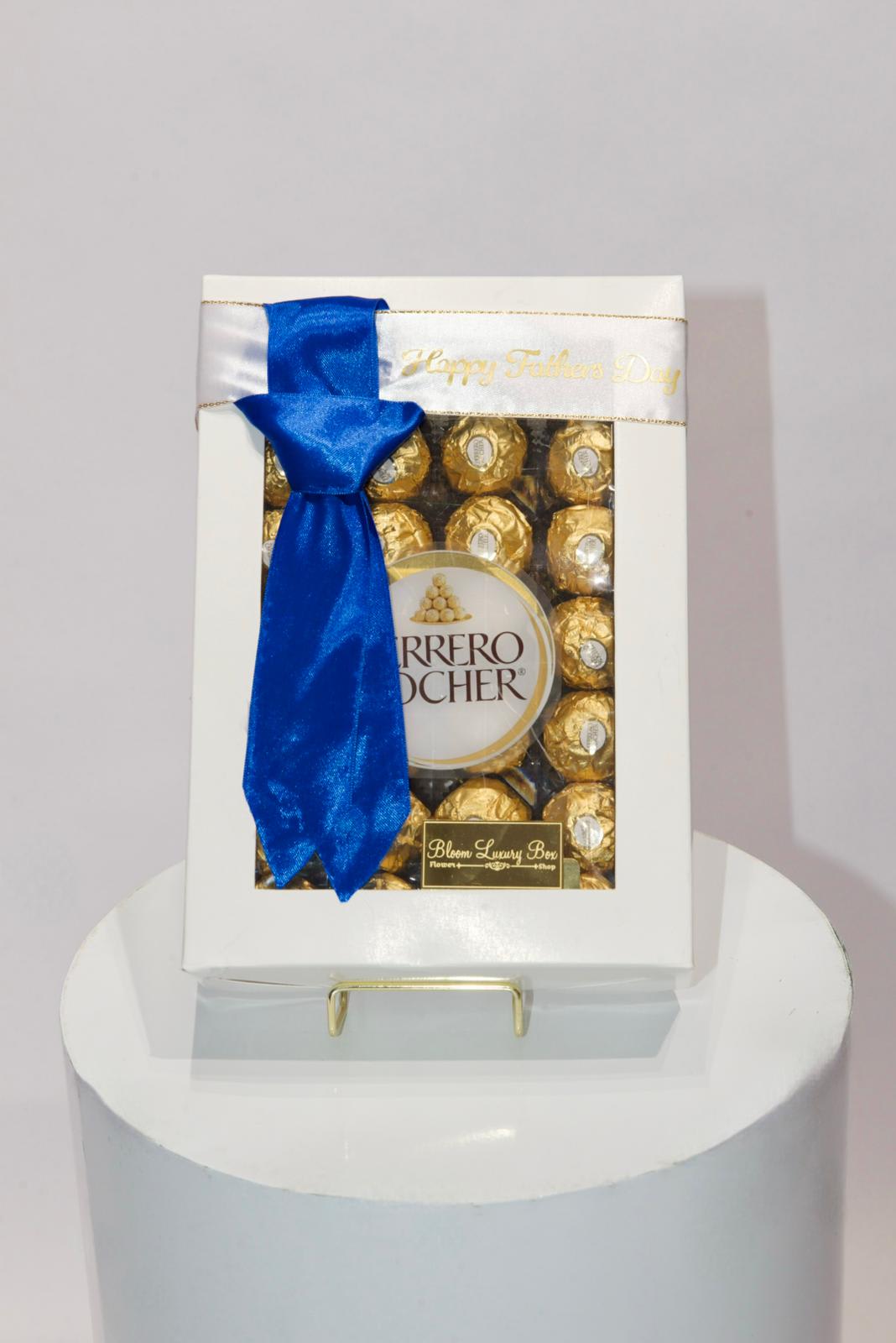 ferrero rocher chocolates gift set - ferrero rocher choclates in a gift box topped off with a blue tie