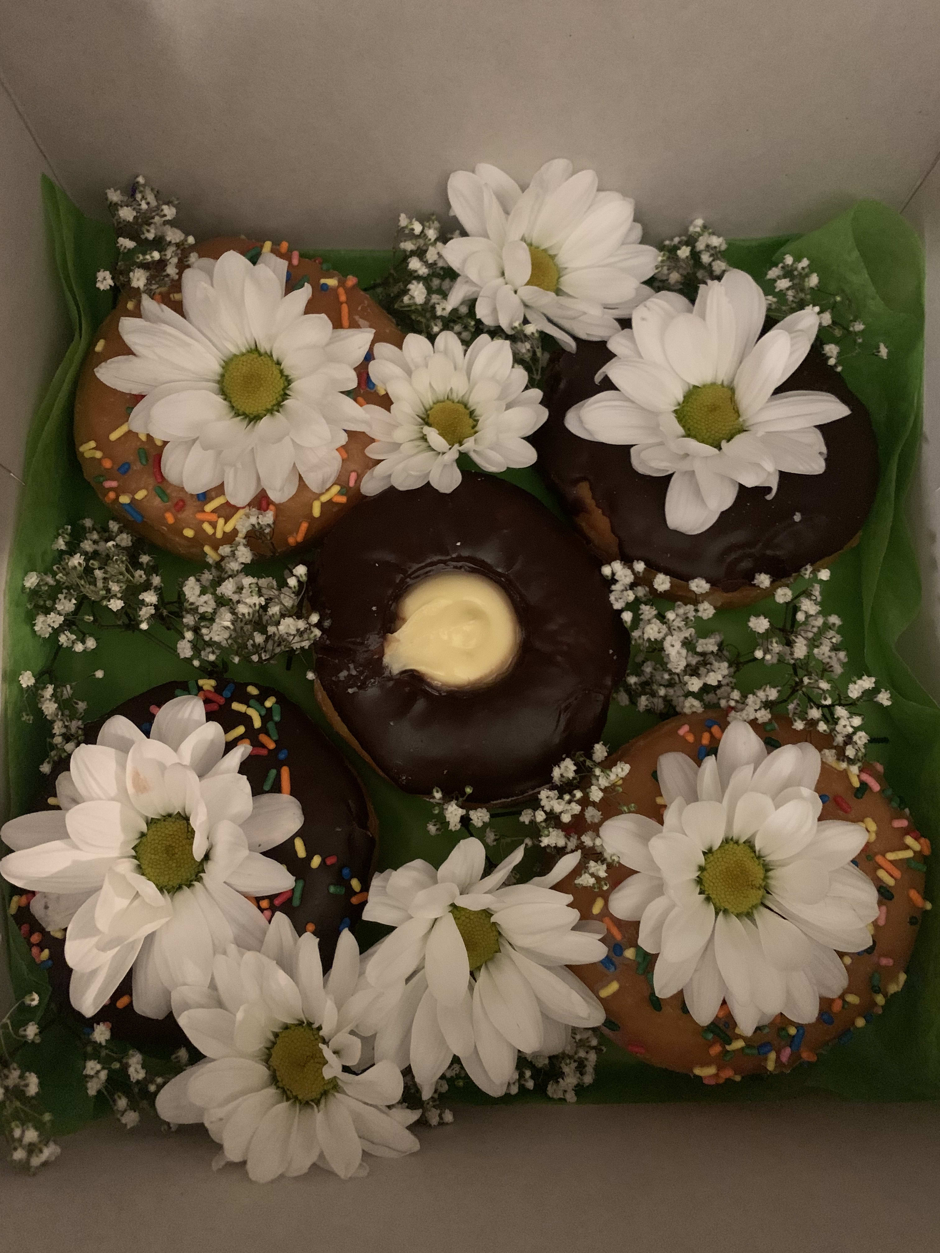 Donuts and daisies  - Whats better than a box of donuts with decorative fresh flowers? Help someone start their day with this sweet surprise!