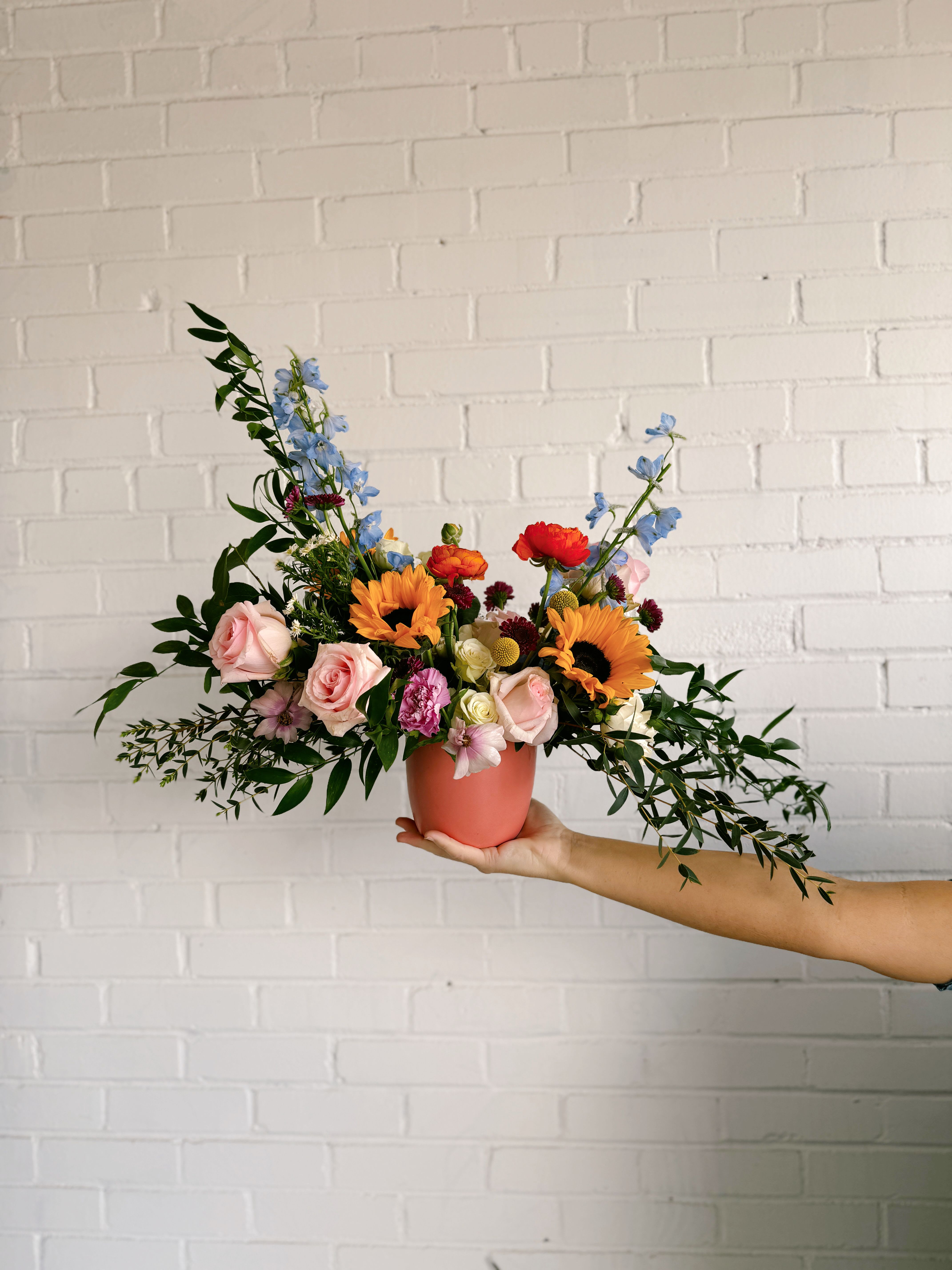 Kayla - This arrangement is uniquely crafted with bright and fresh florals. Arrangement and vase may vary depending on product availability.