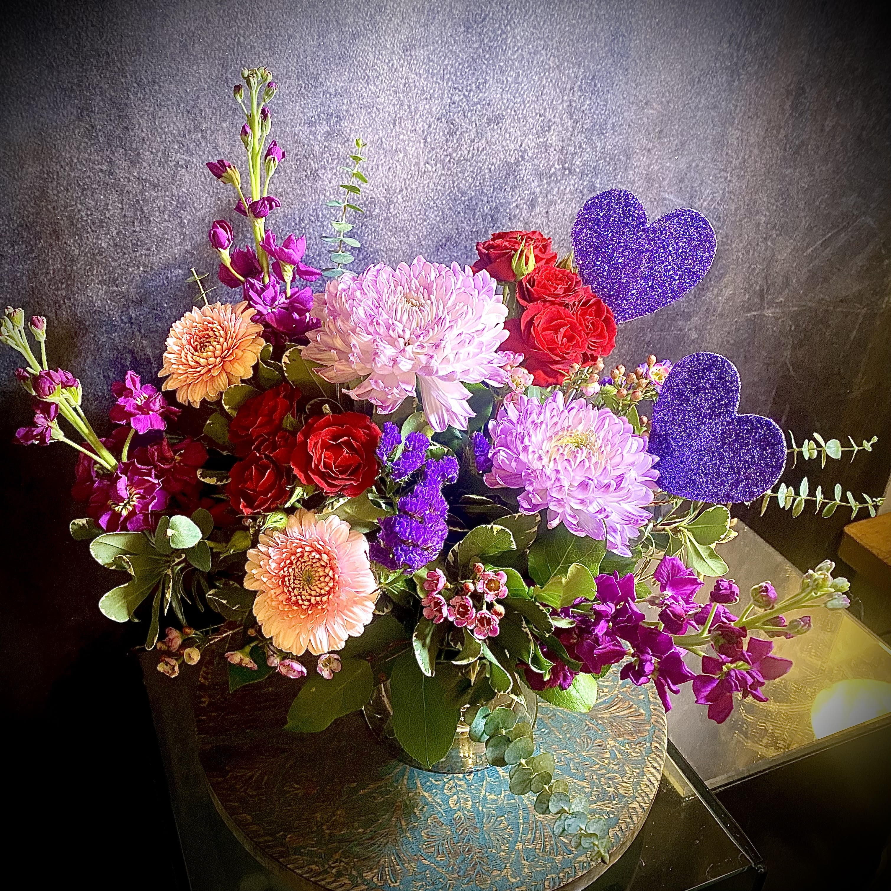 My Beloved Valentine- Available after February 9th  - Send the gift of love and passion with this beautiful and unique arrangement. Perfect for any home or office space, this stunning bouquet is the perfect way to express your love towards Your Beloved. Featuring Chrysanthemums, Roses, and Gerbera daisies with a touch of glitter in a unique heart pick, the My Beloved Valentine is sure to bring joy and show your true affection.