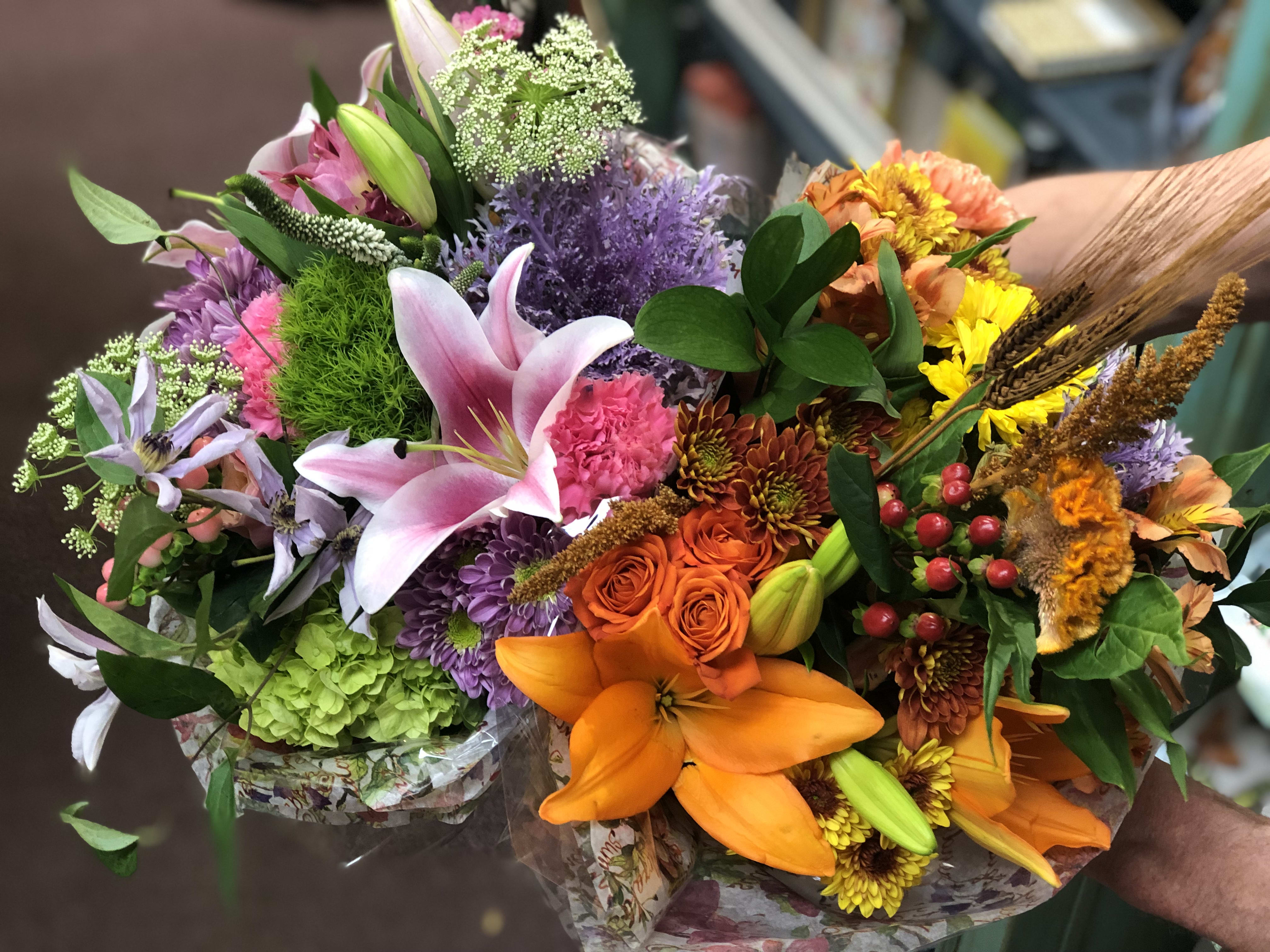 Hand Tied Bouquets - These bouquets are a great mix of flowers. Just specify a the price point and we will do the rest. They are made so that the recipient just needs to re-cut the stems and put into their favorite vase. Great value. All your money goes to flowers. This picture shows two $50 bouquets held side by side. Each bouquet will be beautiful and long lasting. Content will vary according to availability. 