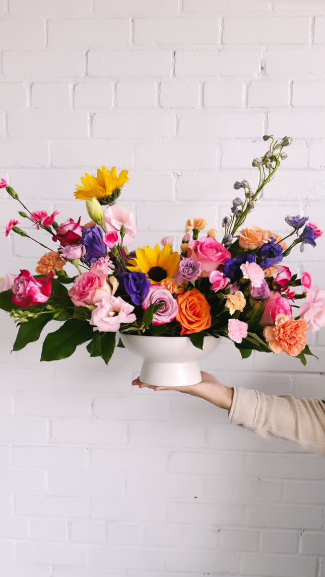 The Stunner - This arrangement is uniquely crafted with the love of all things colorful and definitely a jaw dropper. Arrangement and vase may vary depending on product availability.