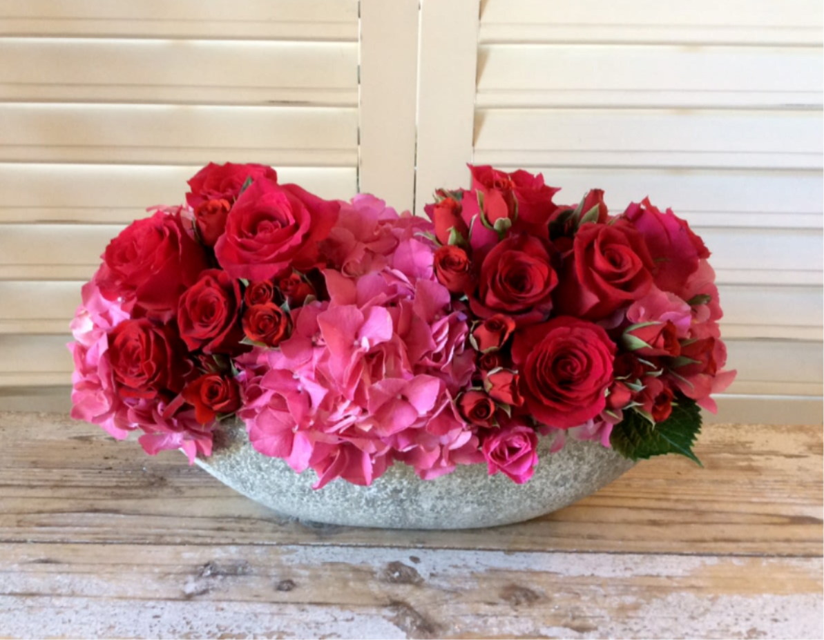 Femme Fatale  - Sweet and romantic, a lush pairing of roses and hydrangea is at home in our stone container. Perfect for home, office or dressing room. 