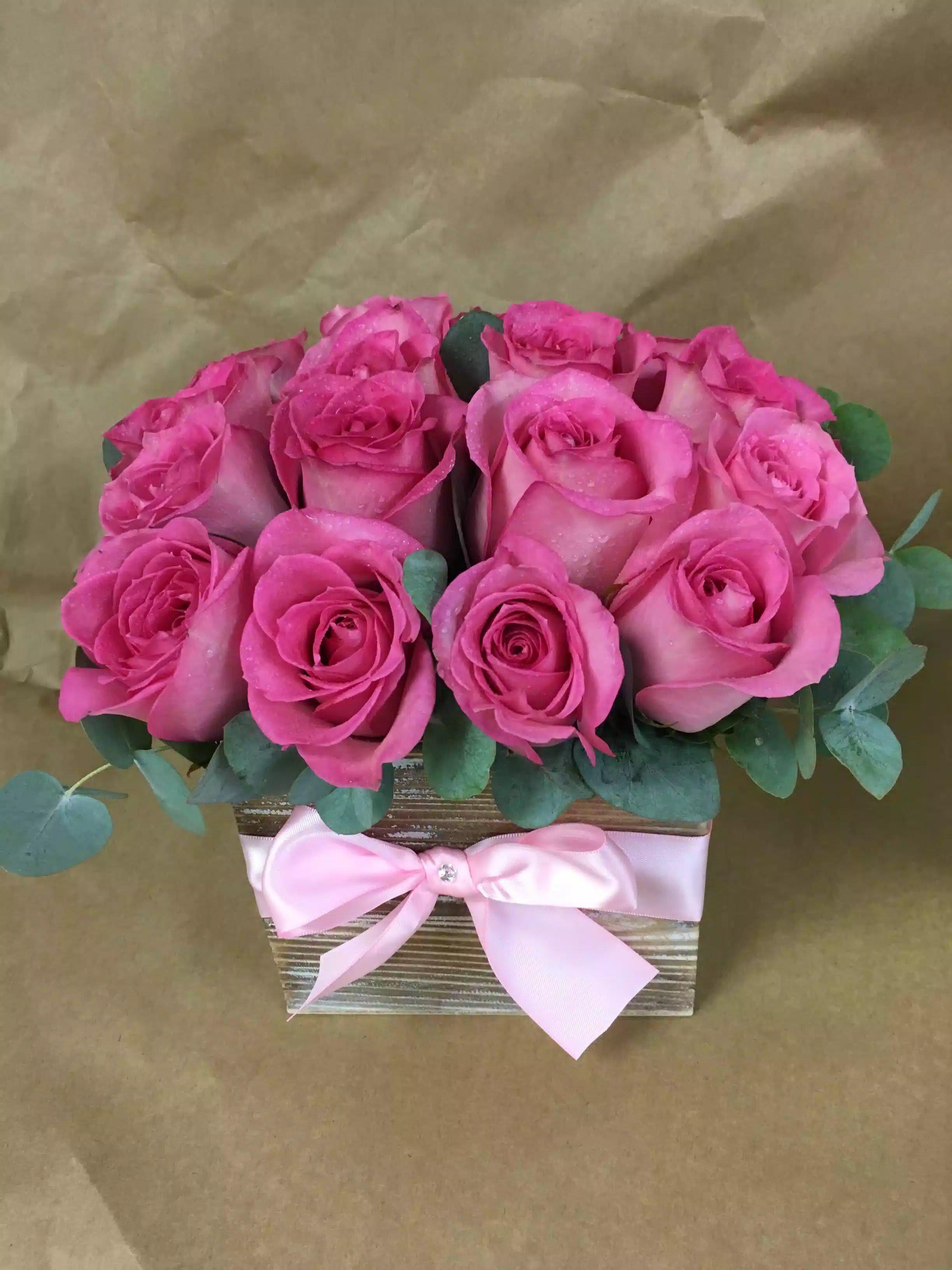 Pretty in Pink - Her heart will beat ever faster when you send this fantastic modern arrangement of 16 roses, accented with ribbon. Long lasting and can we ordered in other colors. 