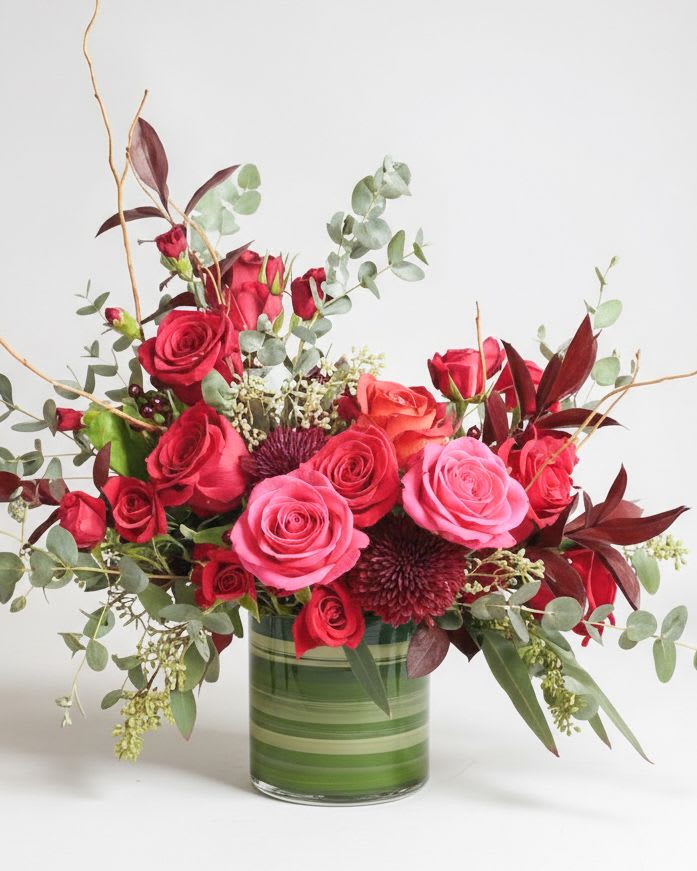Valentine’s Signature - A passionate ensemble of deep red and radiant pink roses that captures the flutter of love. Paired with fragrant eucalyptus in a chic vase, this arrangement is the perfect expression of your heart this Valentine’s Day.