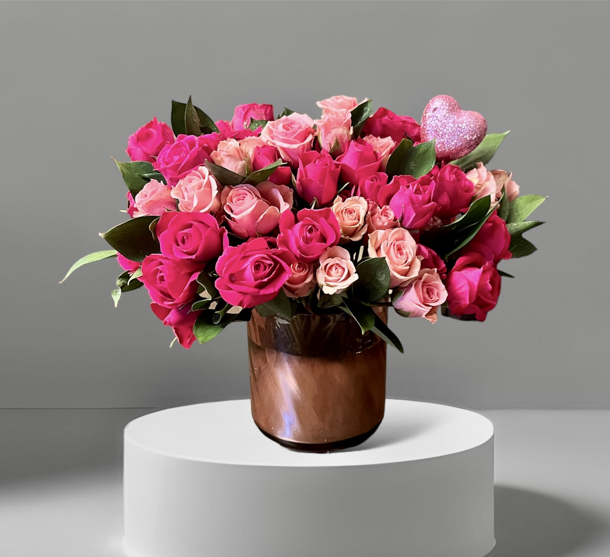 Pinky - A sweet mix of pink spray roses and foliage arranged in a pink vase. A perfect Valentine!