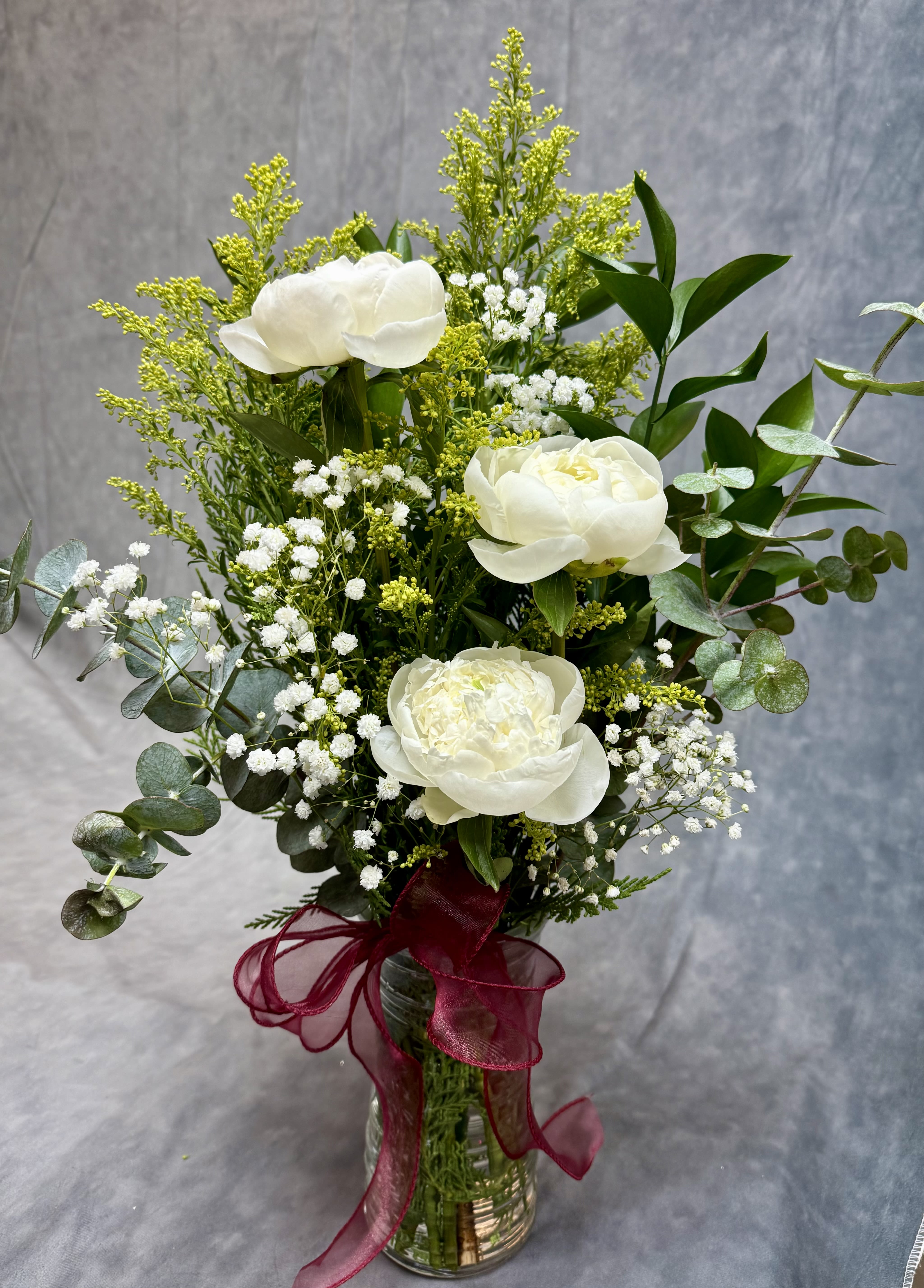 Peonies Lovers Vase - A dreamy vase filled with lush peonies, soft baby’s breath, golden aster, and fresh eucalyptus — designed to highlight the timeless beauty of peonies. Elegant, airy, and perfect for any peony lover. 
