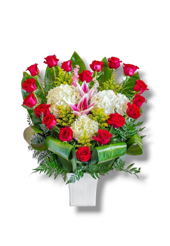 Love Heart by Honey's Flowers - Classic symbols of romantic love and deep passion are carefully arranged to form a captivating heart design. At the center, an elegant lily flower rises gracefully, surrounded by delicate white blossoms and lush green foliage.