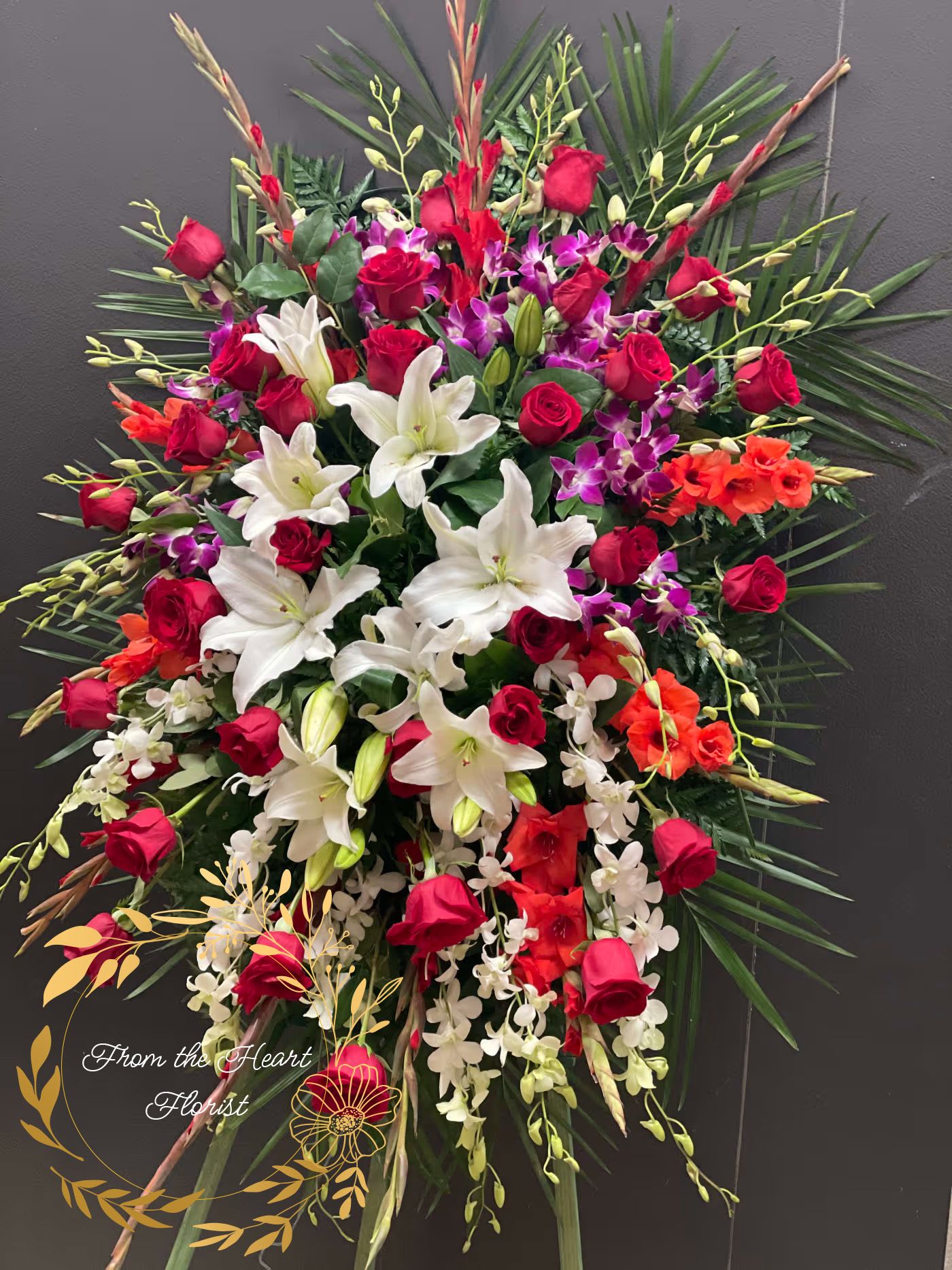Orchid Roses and Lilies Spray  - This Grand and Beautiful standing spray, made with purple and white dendrobium orchid, red roses, white  lily and red gladiolus. This arrangement will defiantly stand out and make a statement on its own, without words. 