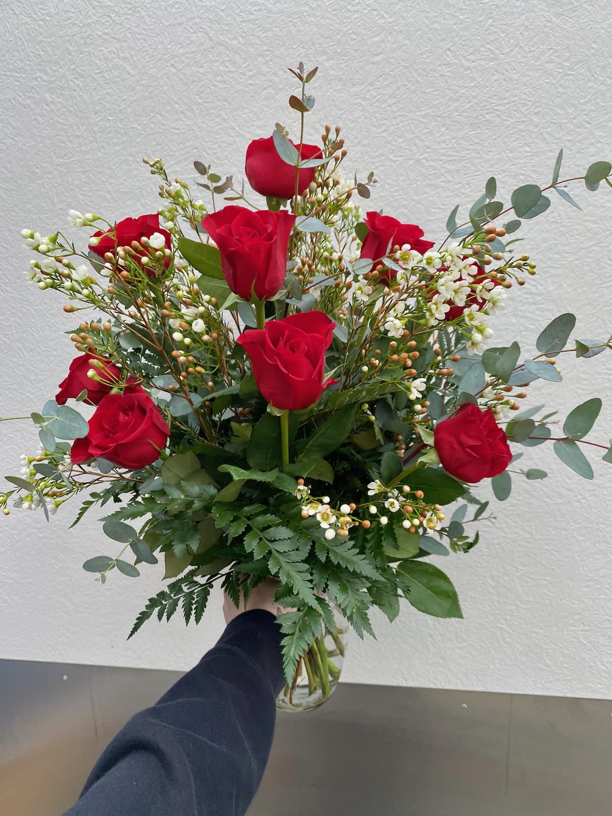 Red Dozen  - A classic arrangement of 12 red roses with white accent flowers and premium greenery.