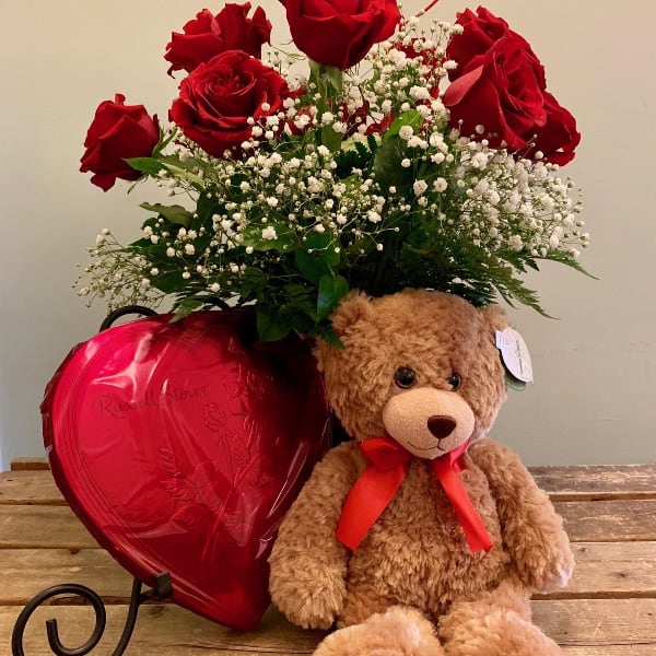 Valentine's Day Special - Russel Stover - Celebrate your Valentine with a dozen luxury fair trade extra long stem Ecuadorian red roses arranged in a vase, premium large bear from First &amp; Main and delicious Russell Stover chocolates in a red heart shape box.  Color of bear may vary.